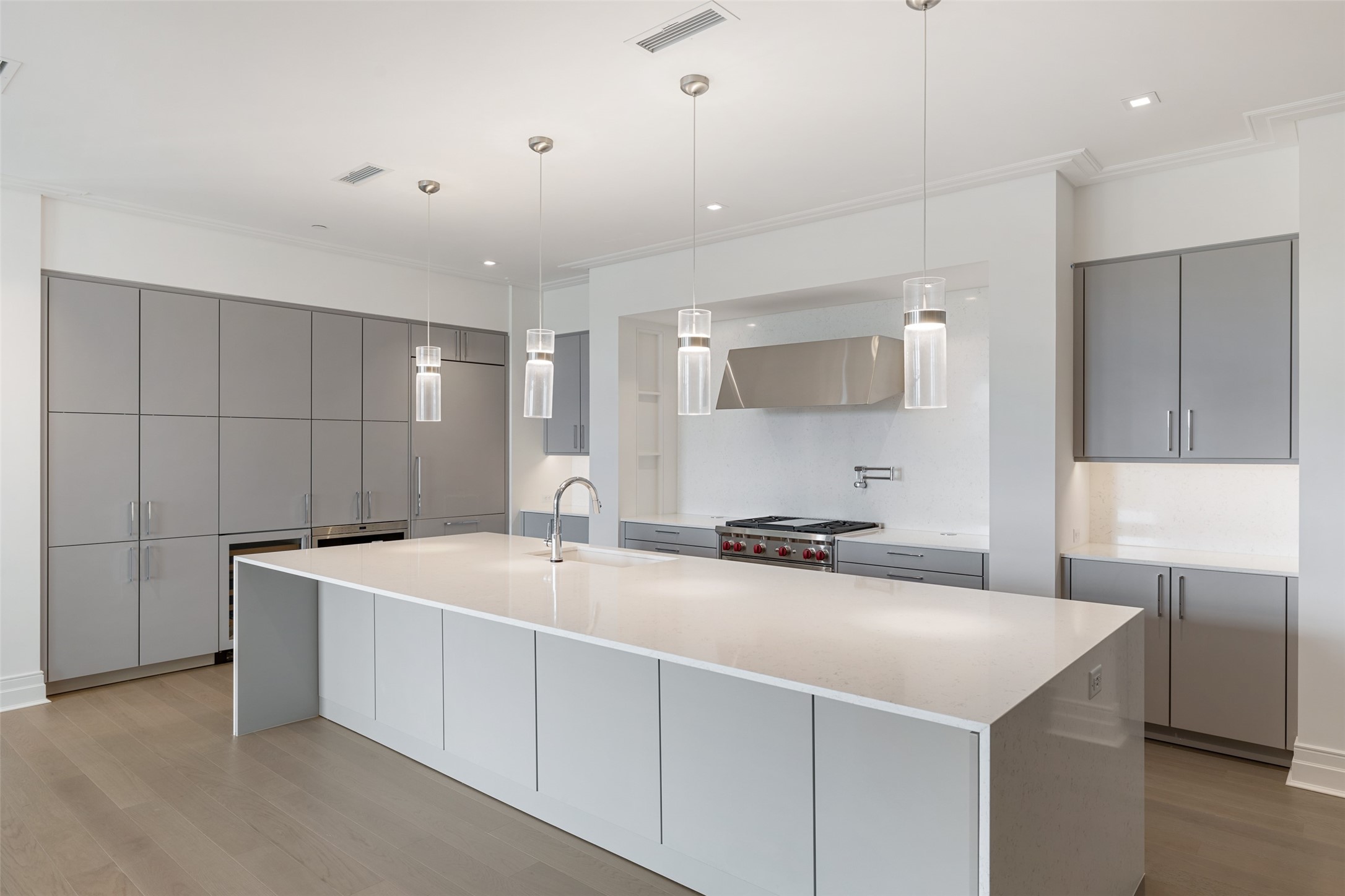 This sleek and sophisticated Kitchen features seamlessly integrated appliances and Quartz cabinets.