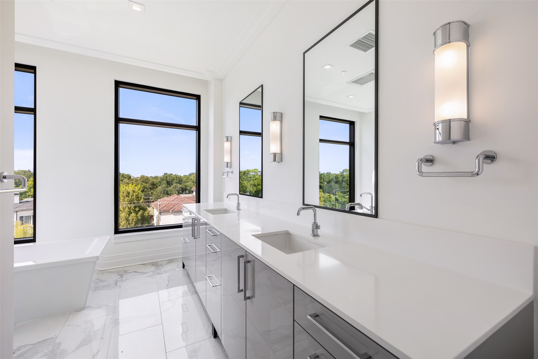 Primary Bathroom with Quartz Countertops has so much natural light.