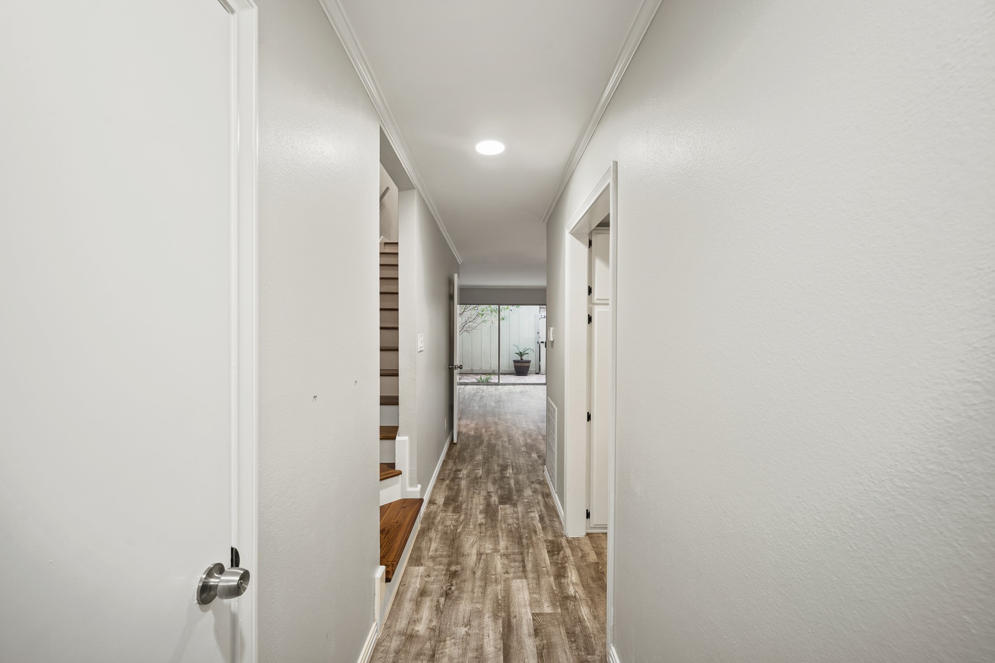 Right when you open the front door, you will notice the wood floors, light paint and open patio with ample light!