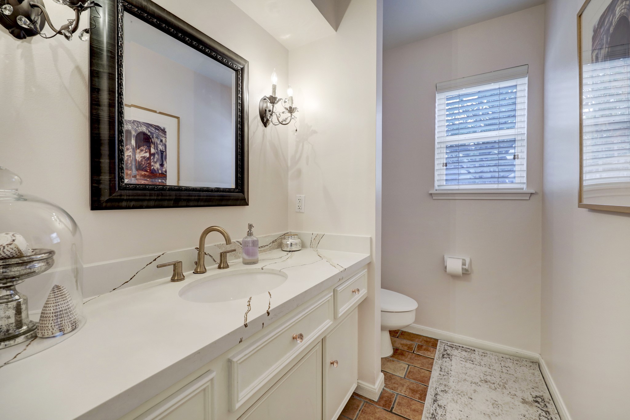 Tastefully updated powder bath is conveniently situated just off the kitchen.