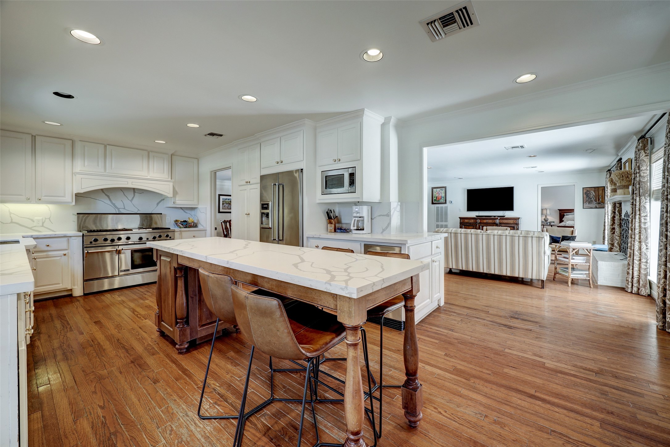Kitchen features a beautiful island with bar seating, top of the line appliances, and upgraded Quartz countertops.