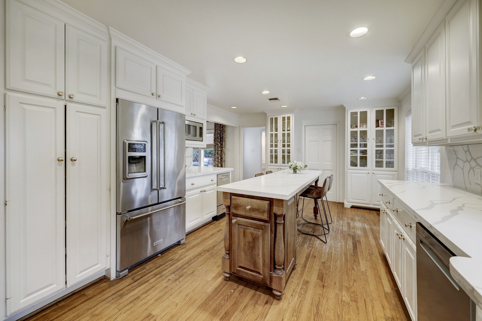 Note the abundant, customized storage space in the updated island kitchen.