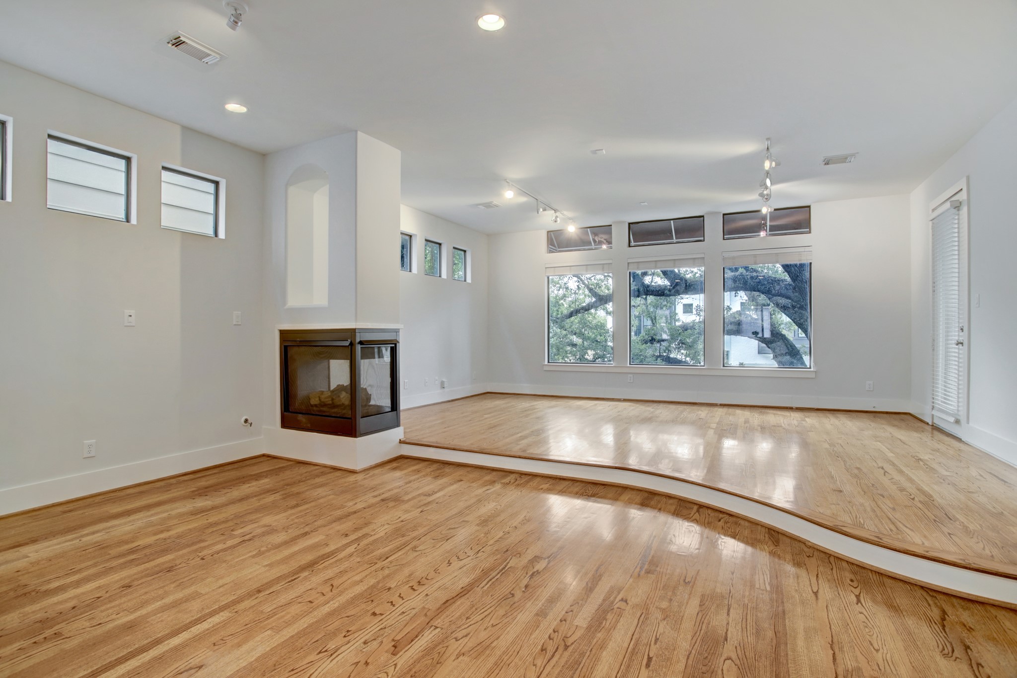 Dining Room and Living area - a wall of windows lights up the room. The beautiful hardwood floors glow with the natural light.