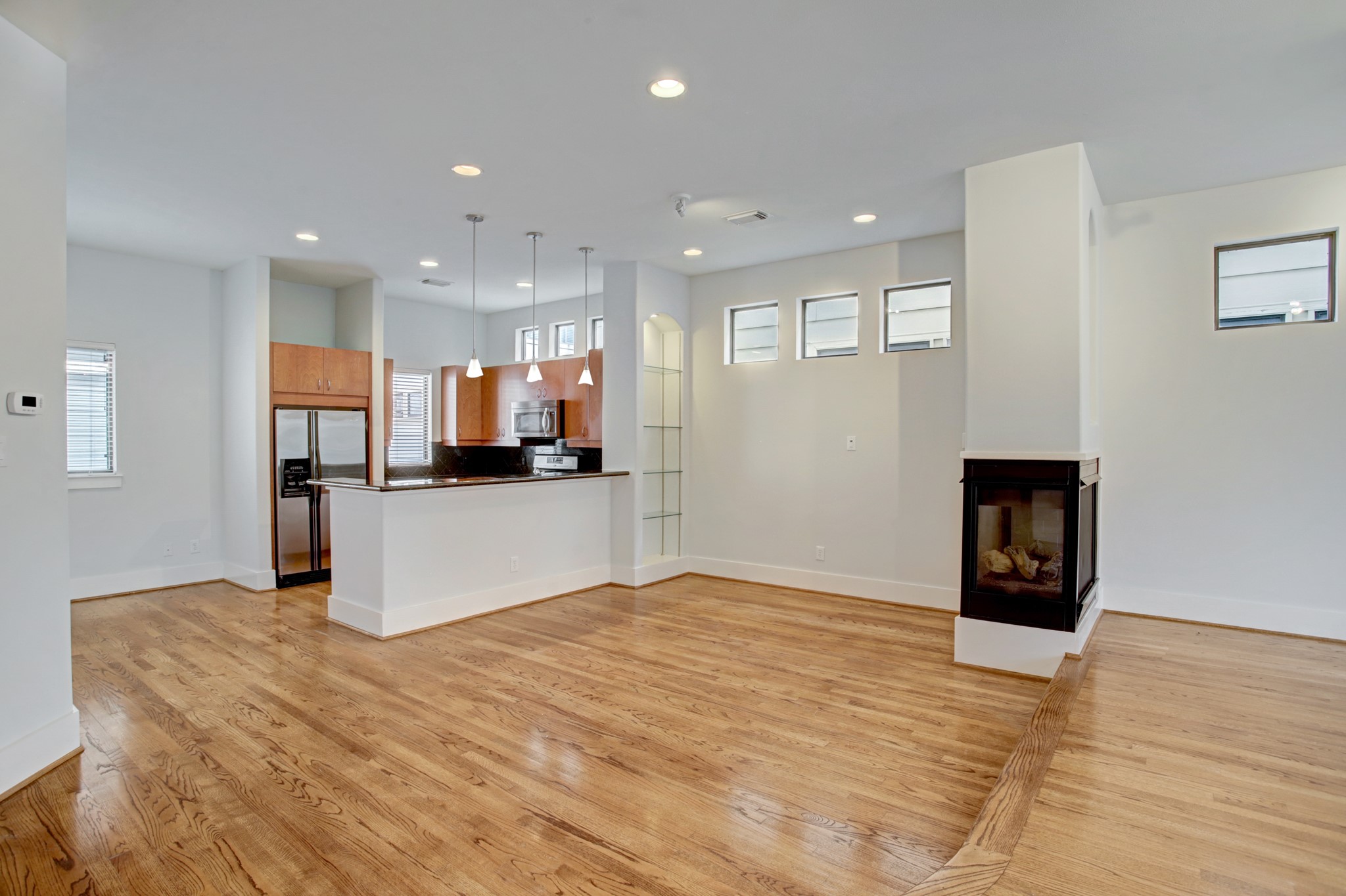 A great view of the kitchen and dining room from the living area. The floors just sparkle with all the natural light.