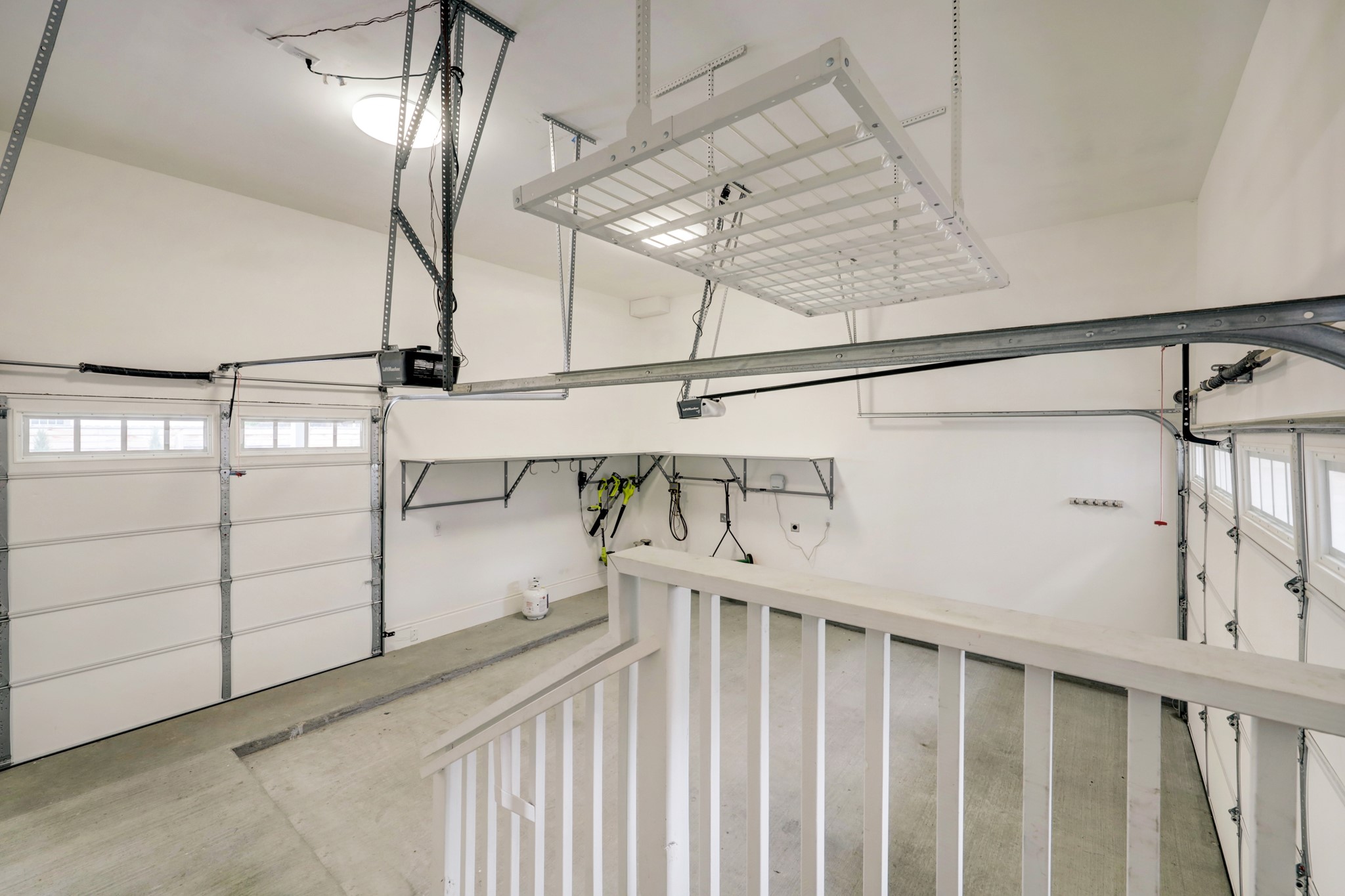 The extra-tall garage includes overhead storage and shelving, EV charging and a third door that opens to the rear yard for easy service access.