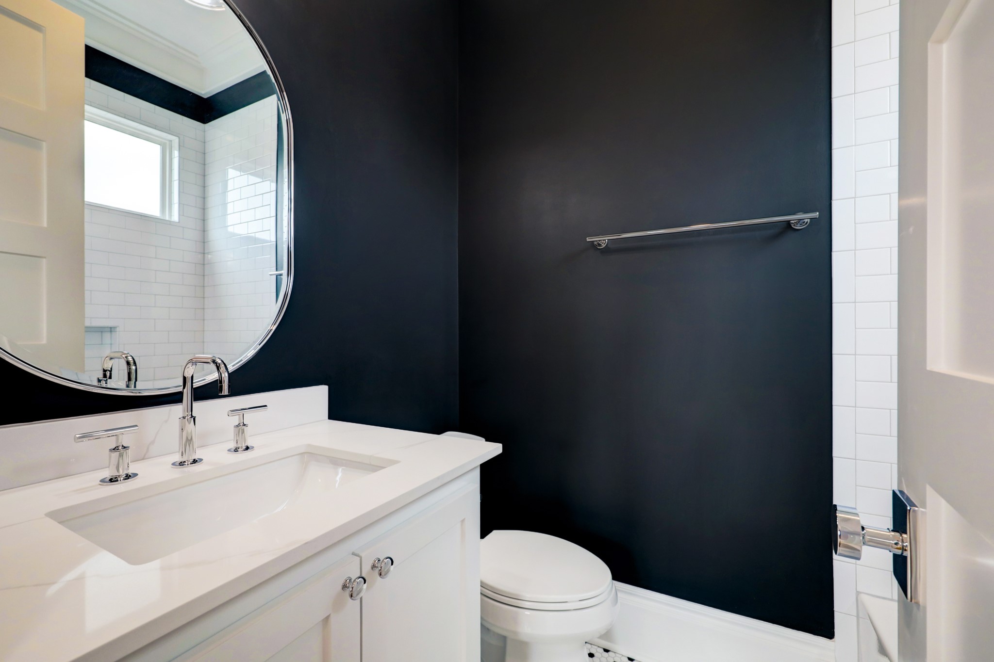  This windowed bathroom shines with floor-to-ceiling tile and chic navy paint.