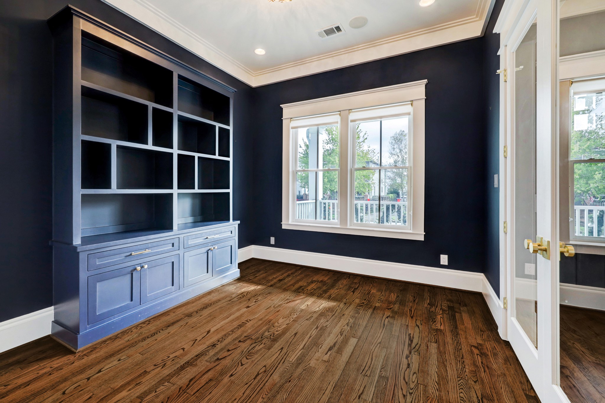 The study features beautiful blue built-in cabinetry and designer paint, porch views and an attached​​‌​​​​‌​​‌‌​‌‌​​​‌‌​‌​‌​‌​​​‌​​ bathroom.