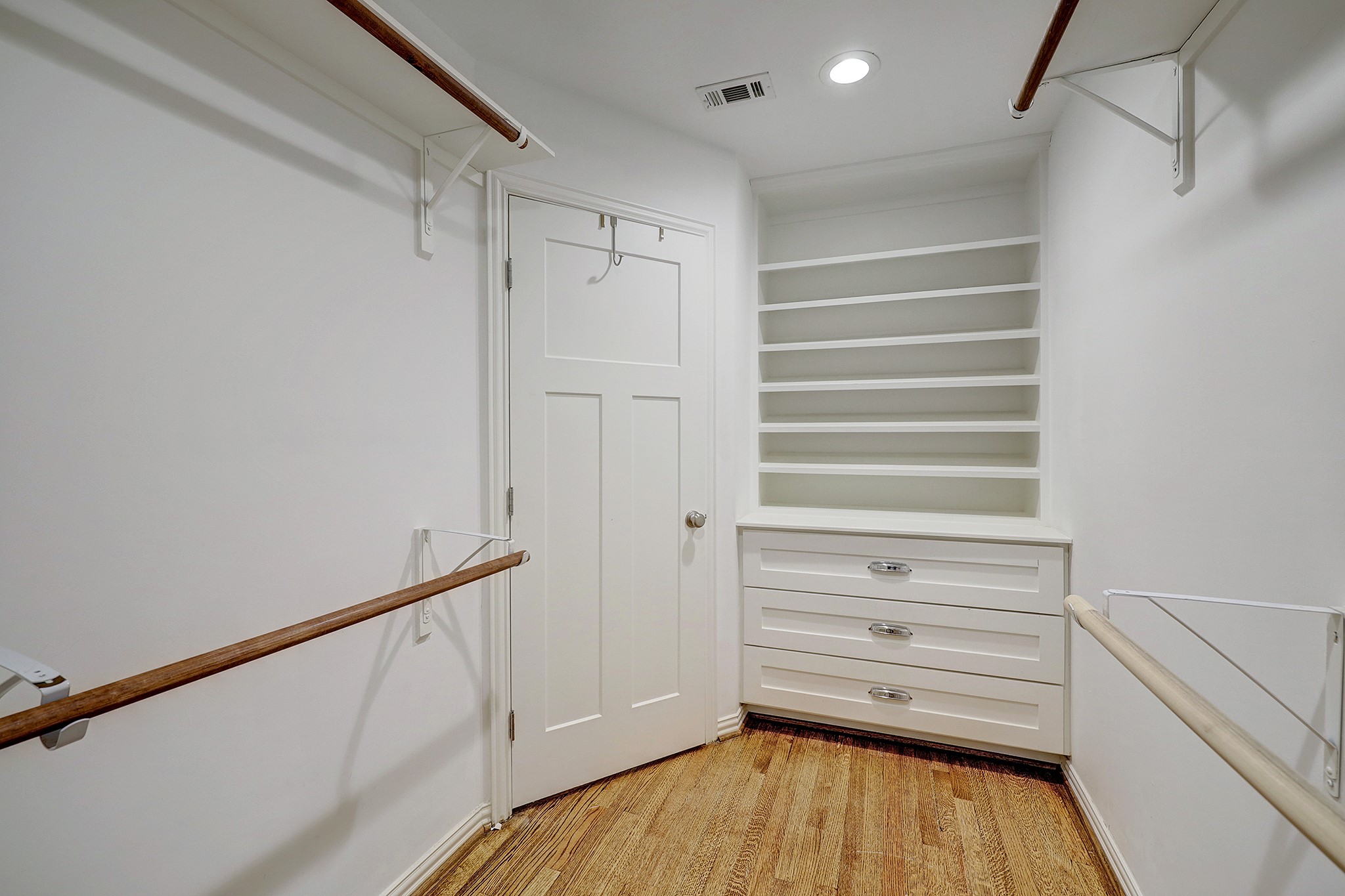 Spacious primary closet with built-ins.