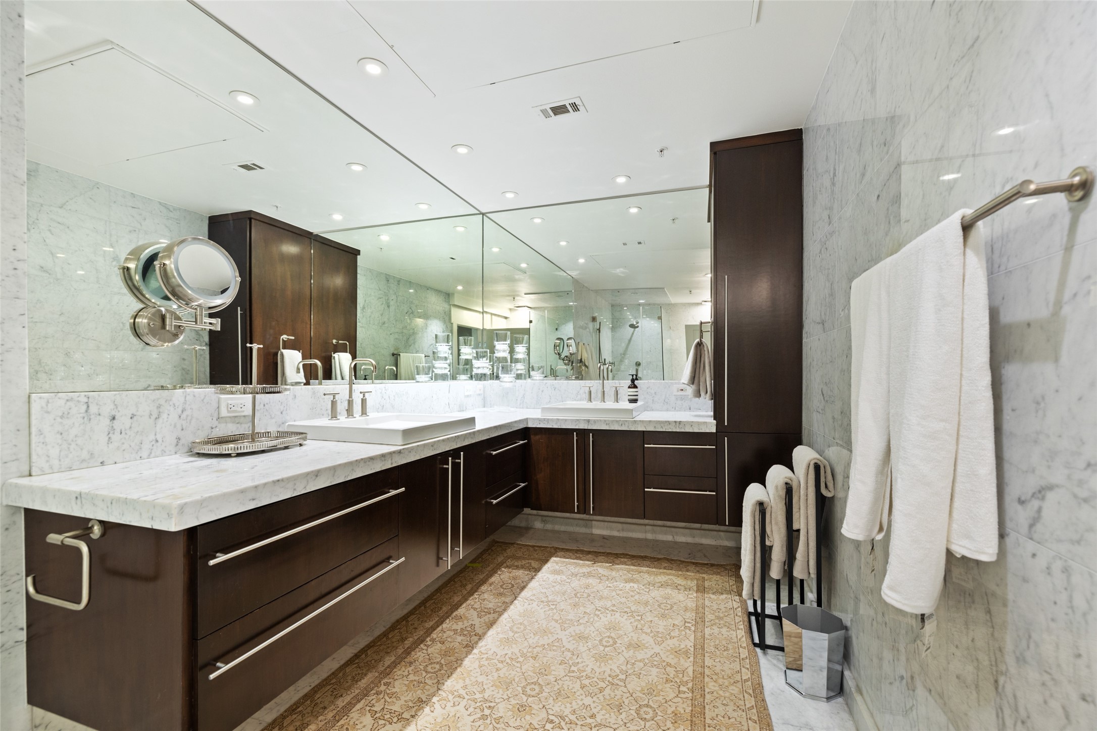 The Primary Bath is both stylish and functional with a large walk in shower, marble counters, and handsome finishes.