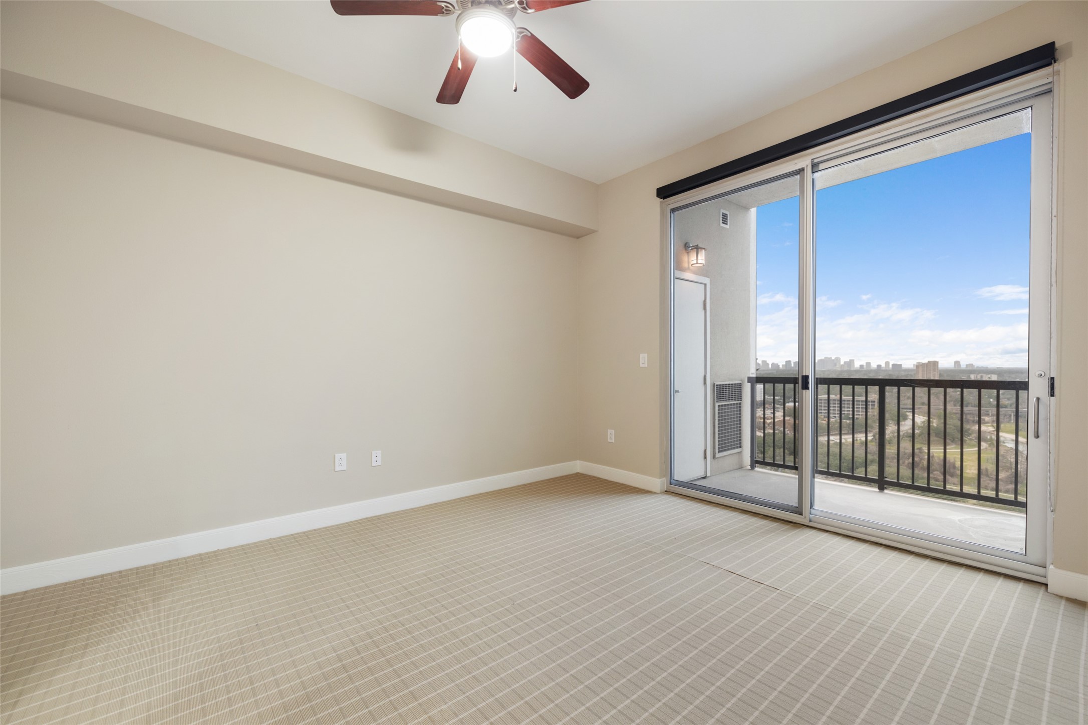 Large Bedroom with private patio with some of the best views in Houston! There is a small storage closet off the balcony.