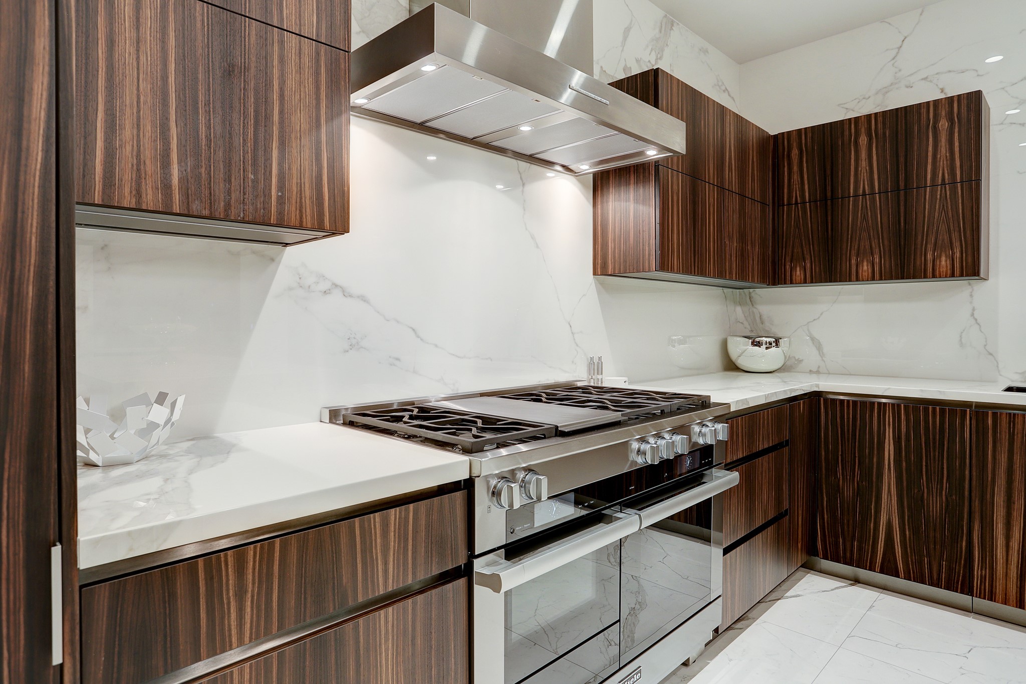 A closer view of the beautiful cabinetry, Neolith counters and stainless steel appliances.