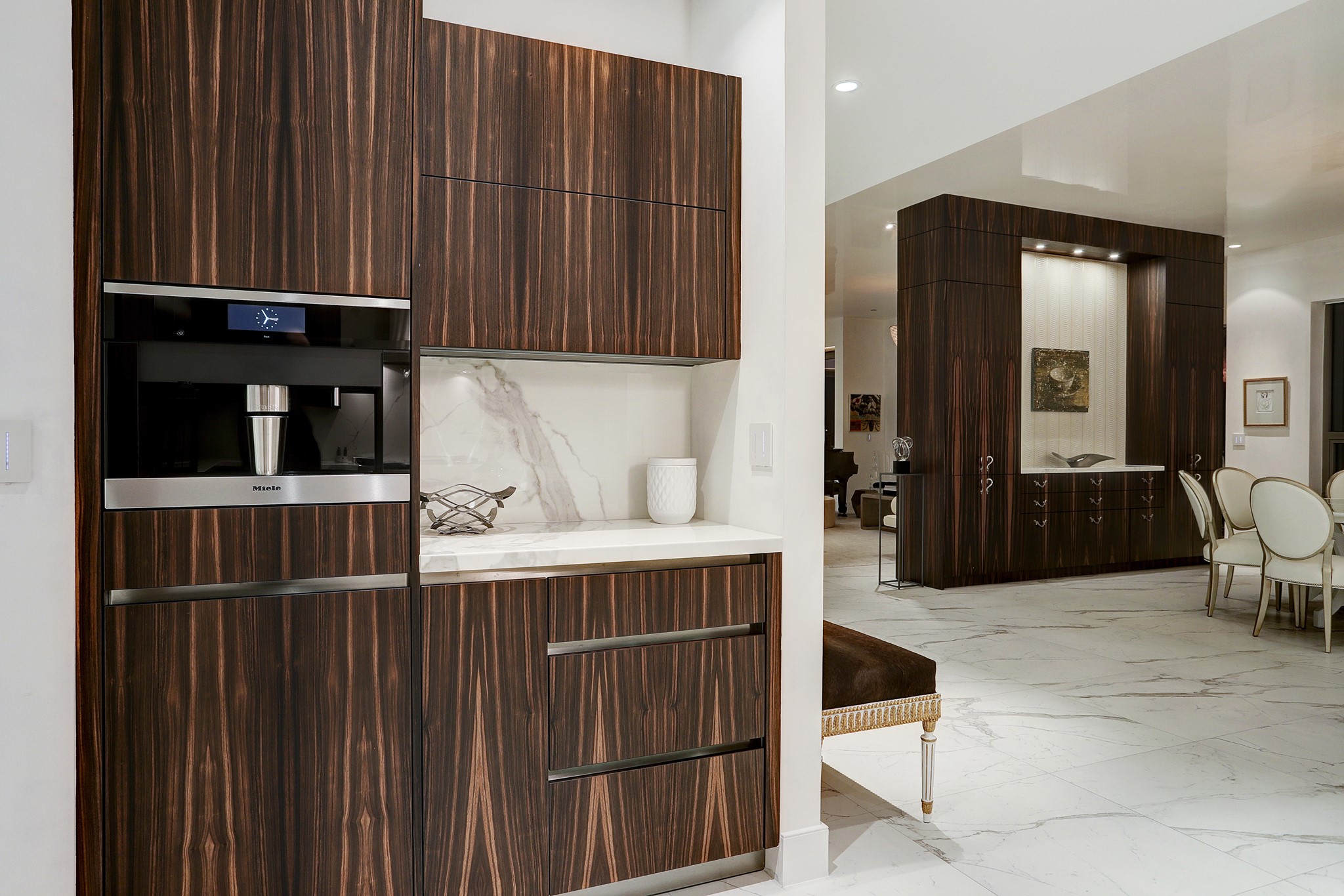 The Kitchen also features a built-in Miele coffee machine with additional built-in counter and storage.