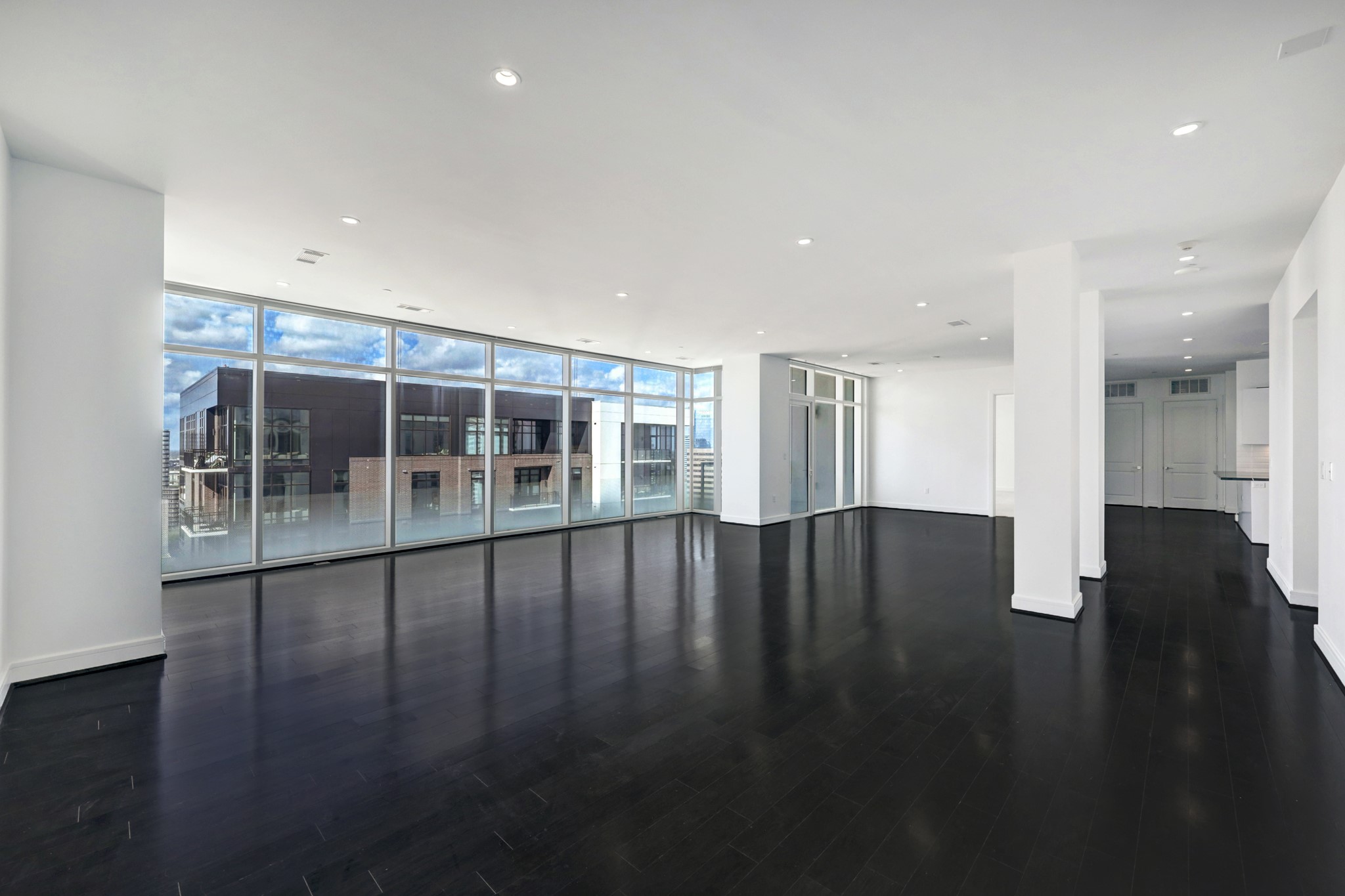 The large game room  is located at the South end of the residence, where the secondary bedrooms are found. Floor to ceiling windows with solar shades line the west wall of the the residence.