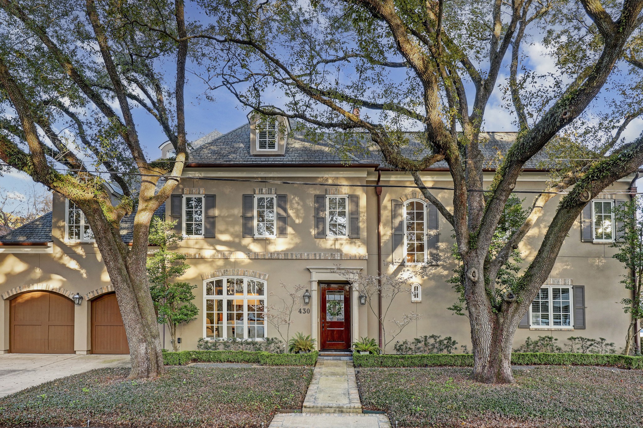 Stunning Country French home on corner lot, custom designed by award-winning Houston architects, Robert Dame Designs. Impeccable custom construction & high-quality engineering. Three blocks from new entrance to Memorial Park!
