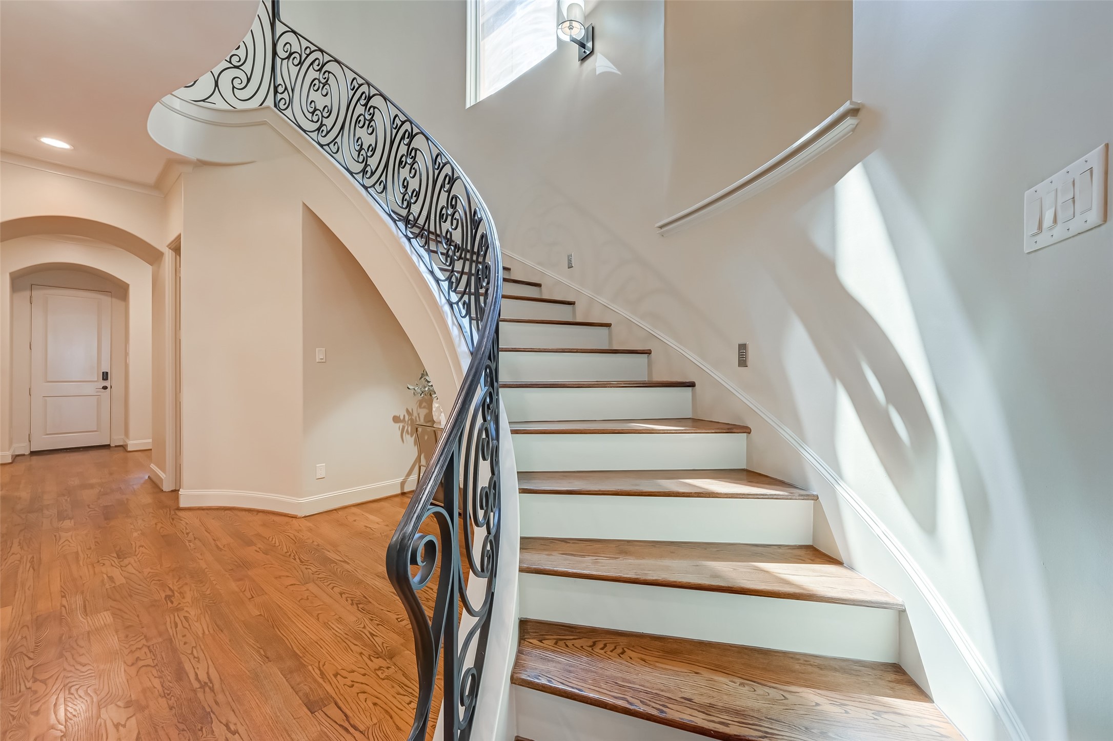 The wrought iron sweeping staircase is such a great architectural feature of this home!