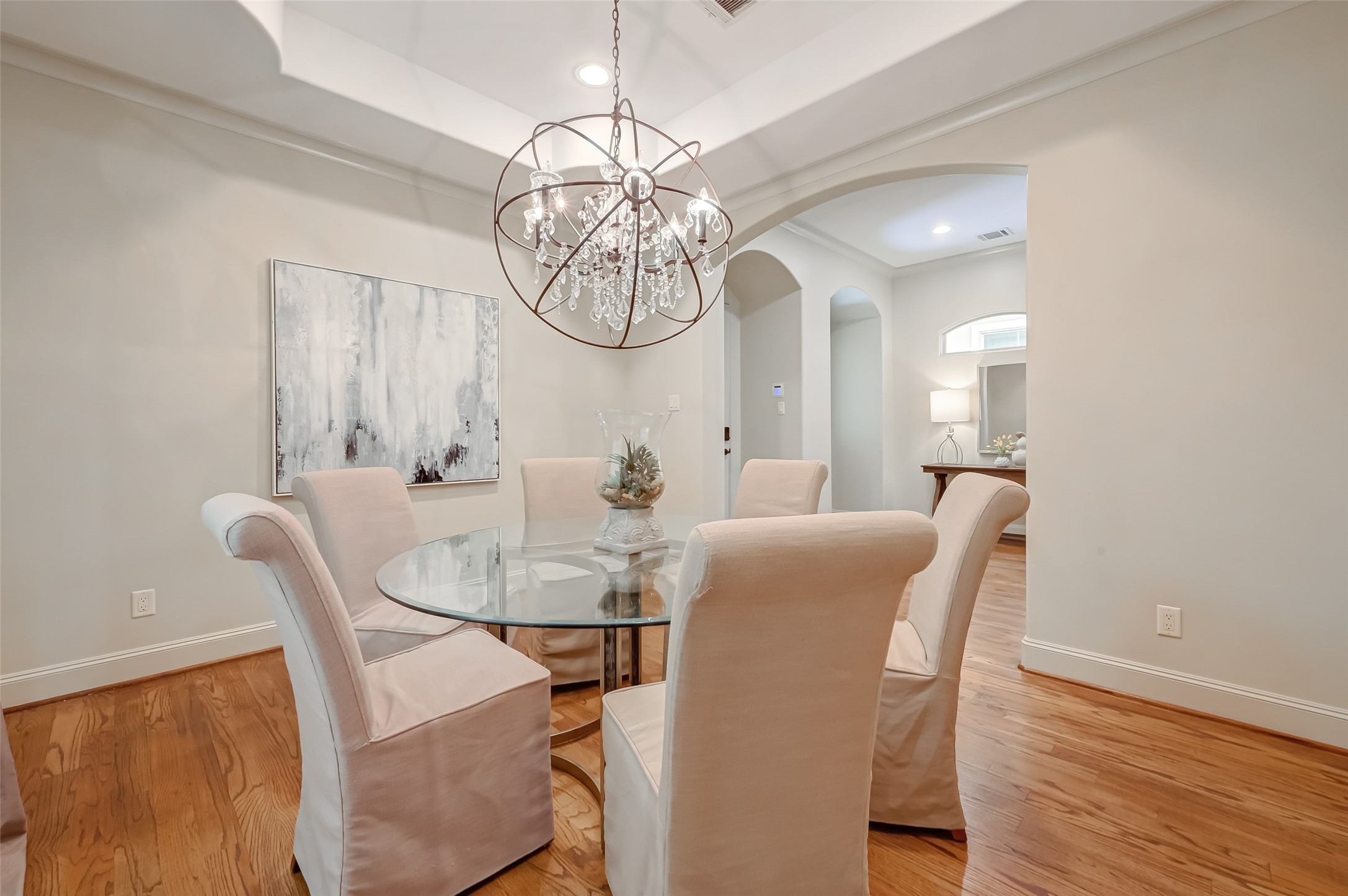 The formal dining room adjacent to the kitchen offers drapes and coffered ceiling, and can accommodate a great  dining room table to celebrate any events with your family and friends. Chandelier is excluded from the sale.