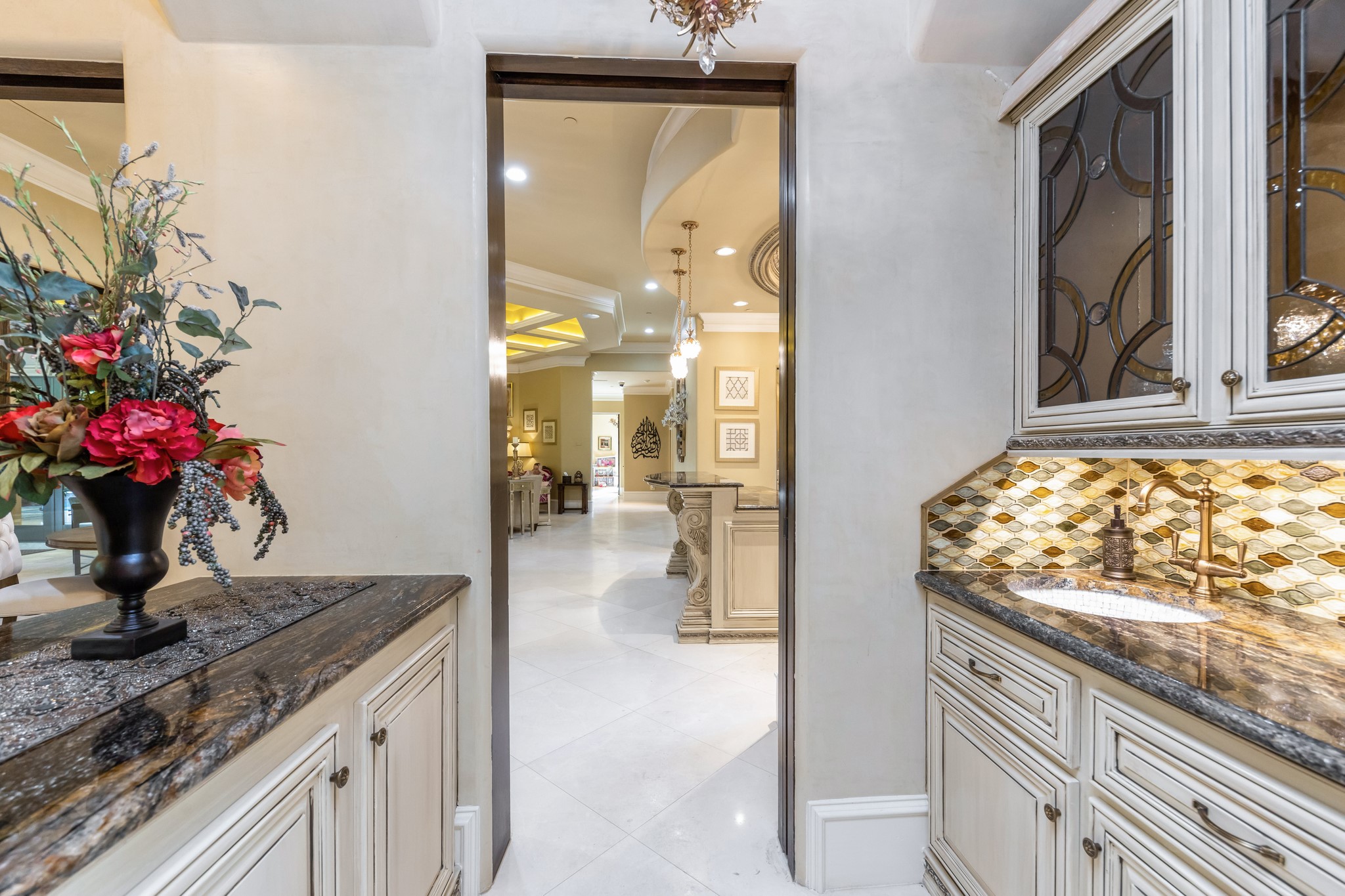 Connecting the formal dinning to the kitchen, you will find a wet bar with tons of storage and custom lighting.