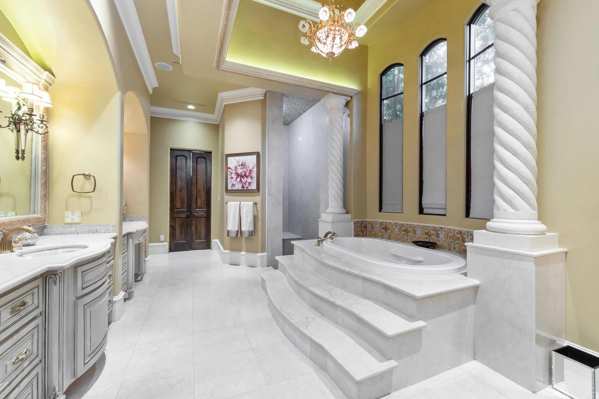 Entering the spa-like bath you will find 14’ barrel ceilings with gorgeous tilework, a custom lavish stone  jetted tub, separate walk in shower,  custom designed cabinets, with his and her massive walk-in closets. 
