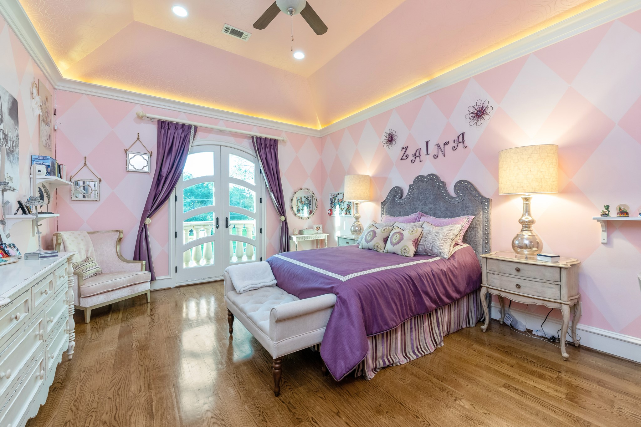 This room is fit for a princess! French entry doors leading into the bathroom. Located near the barrel vaulted art gallery/hallway with trayed ceilings with recessed lighting, custom paint design, generous walk-in closet with custom built-ins.