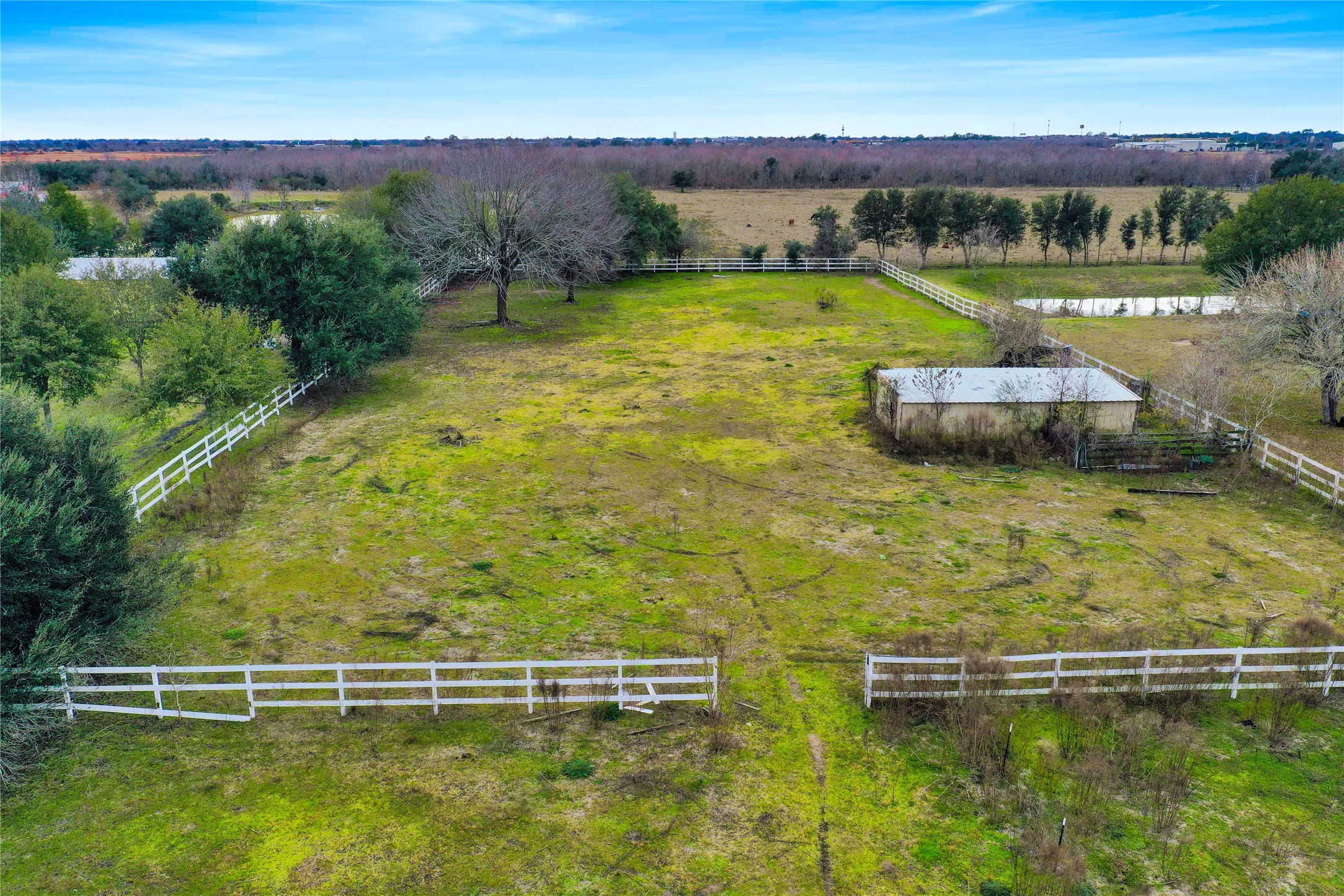 3rd crossed fenced pasture with barn
