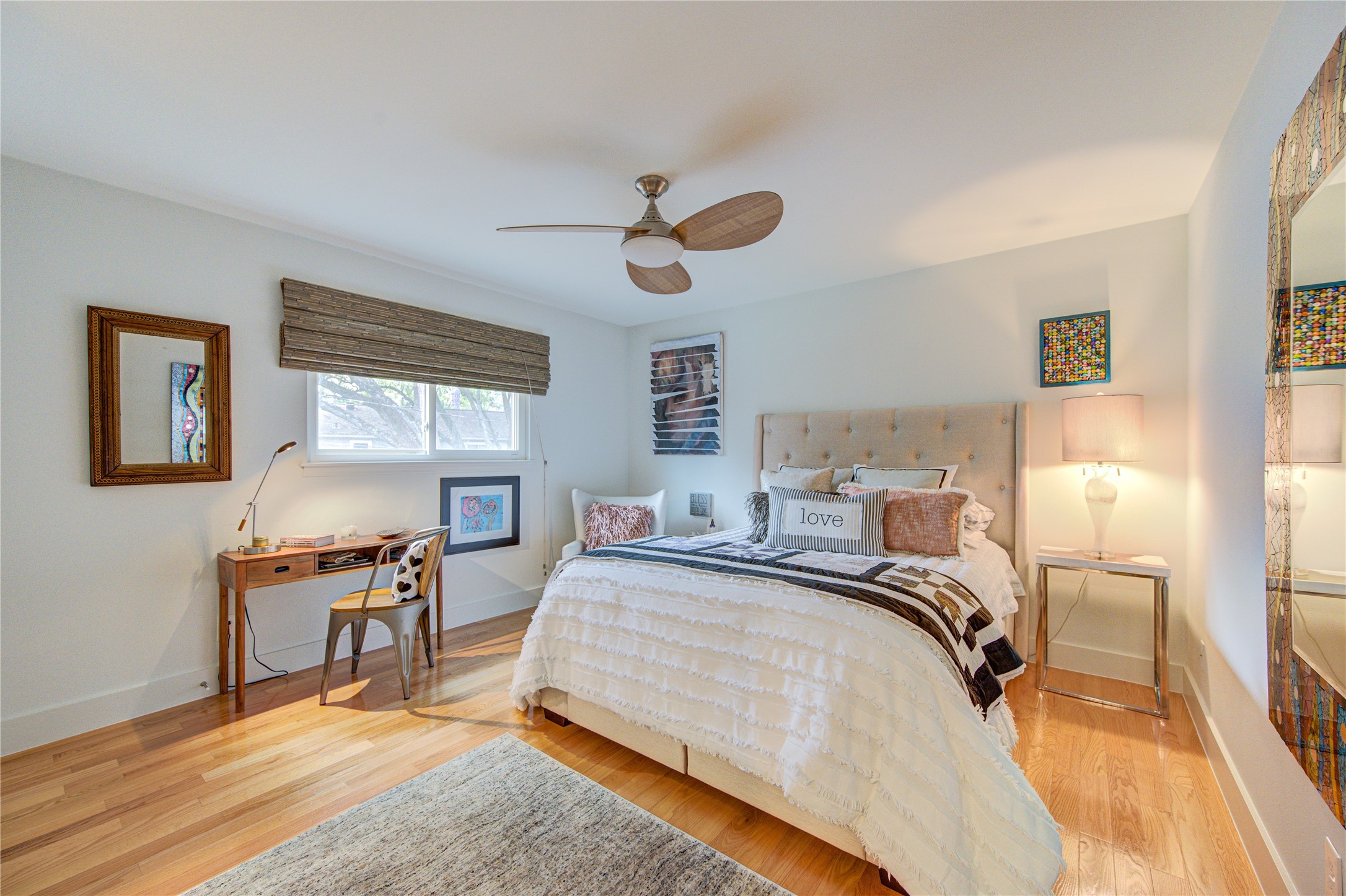 All the crown molding was removed upstairs with modern baseboards added to match the modern look of the downstairs. This spacious bedroom easily accommodates a queen bed with lots of extra space.