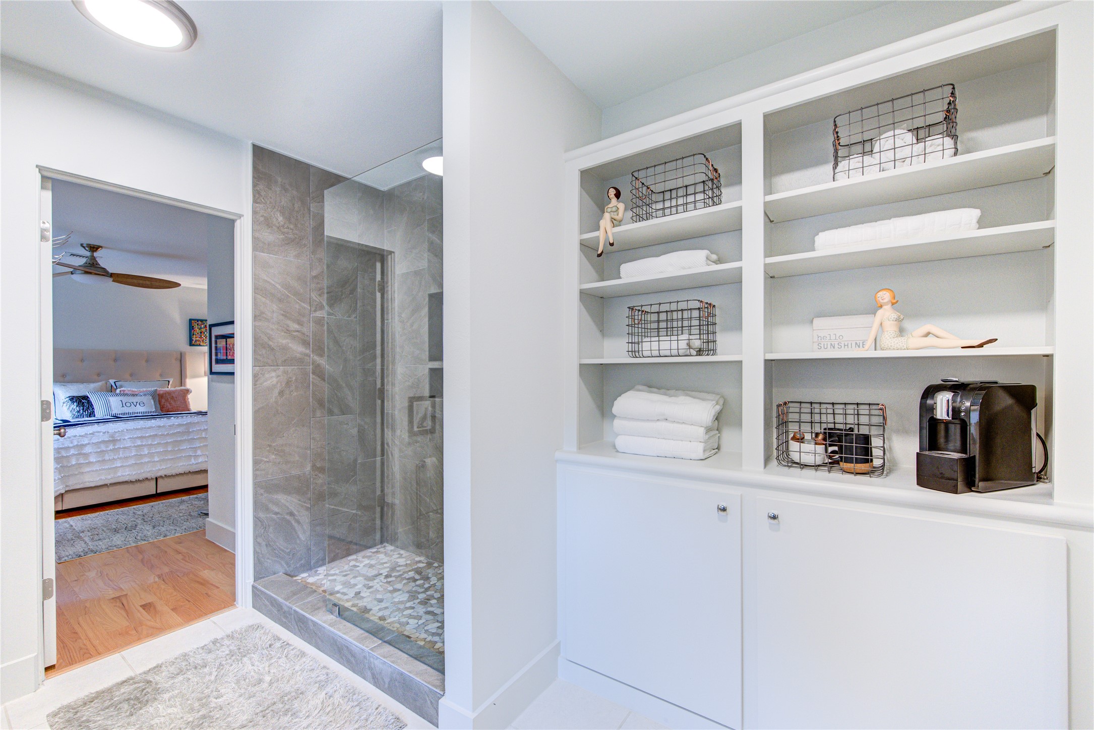 It is rare to find so much storage in a bathroom, but the former door to the bathroom has been converted into a built in cabinet with shelves for additional storage.