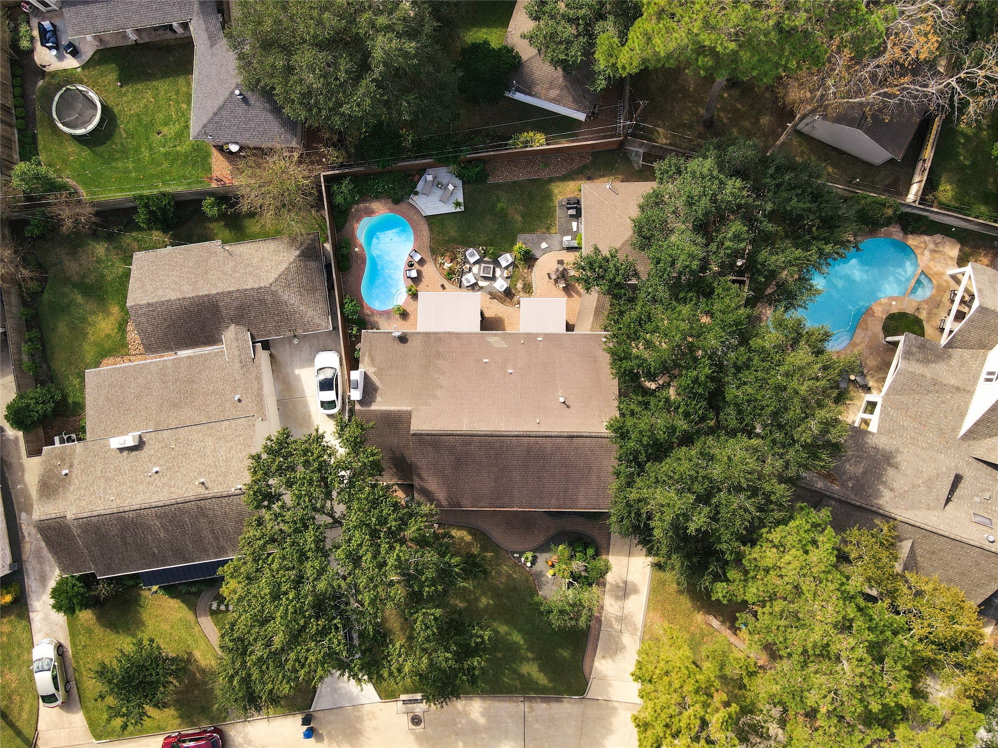 Aerial view highlighting the Estate pie shaped lot that is so hard to find in this neighborhood. In addition to an expansive front yard, there is a double wide backyard offering a pool and private green space.