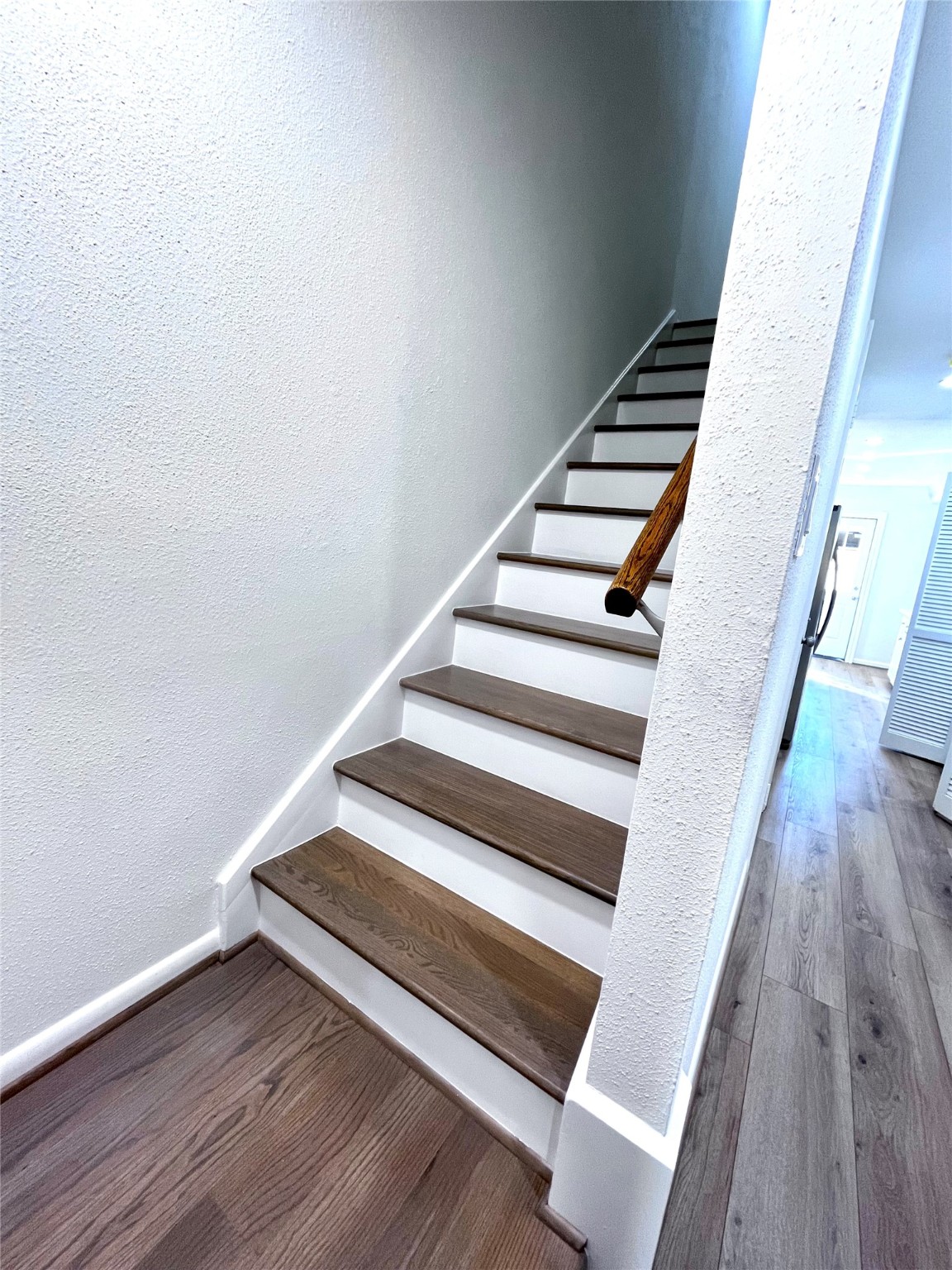 One set of staircase leads to the bedrooms. It was recently rebuilt with hardwood.