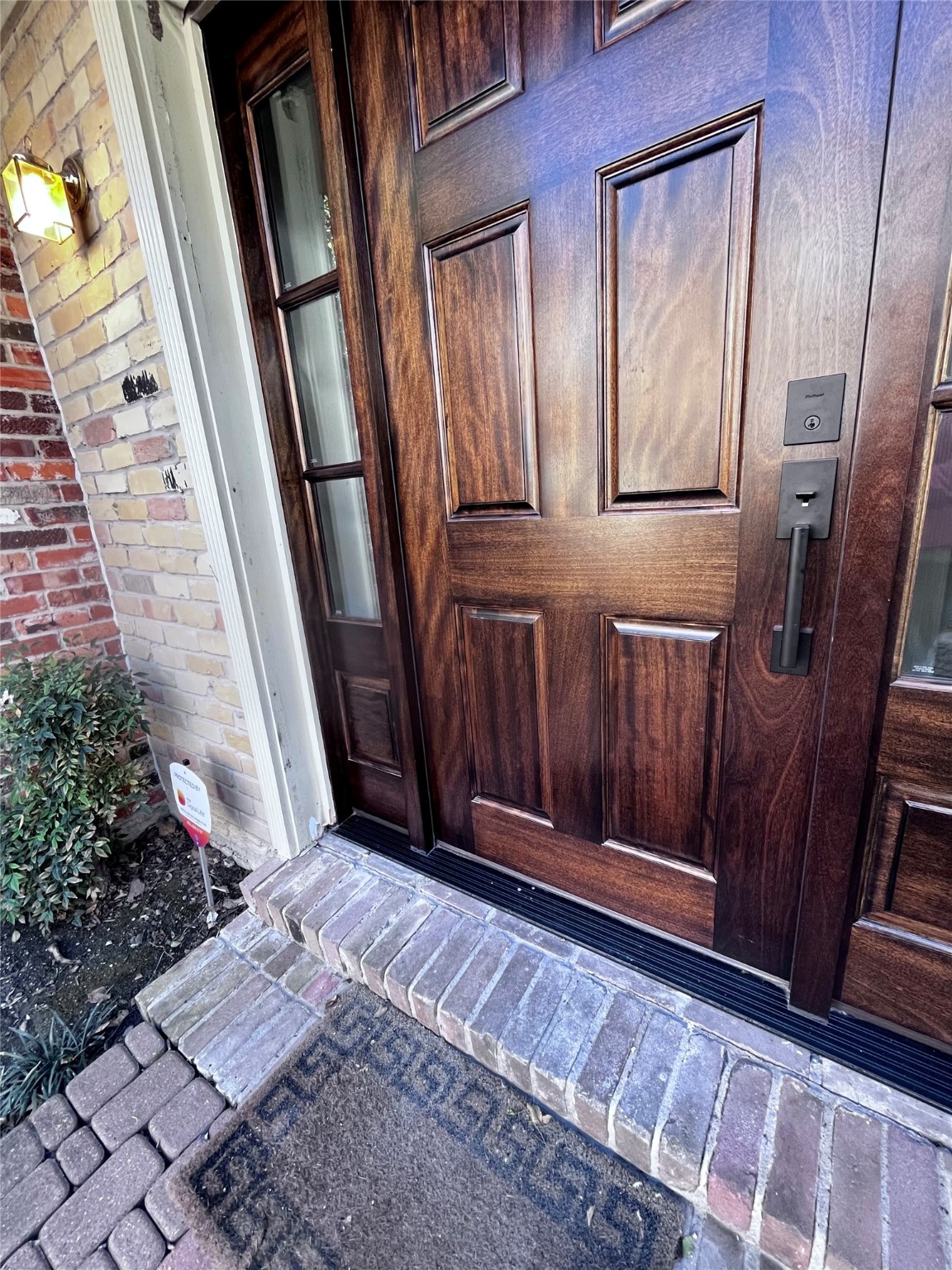 Beautiful front door with side glass paneling starts the wonderful touring experience.