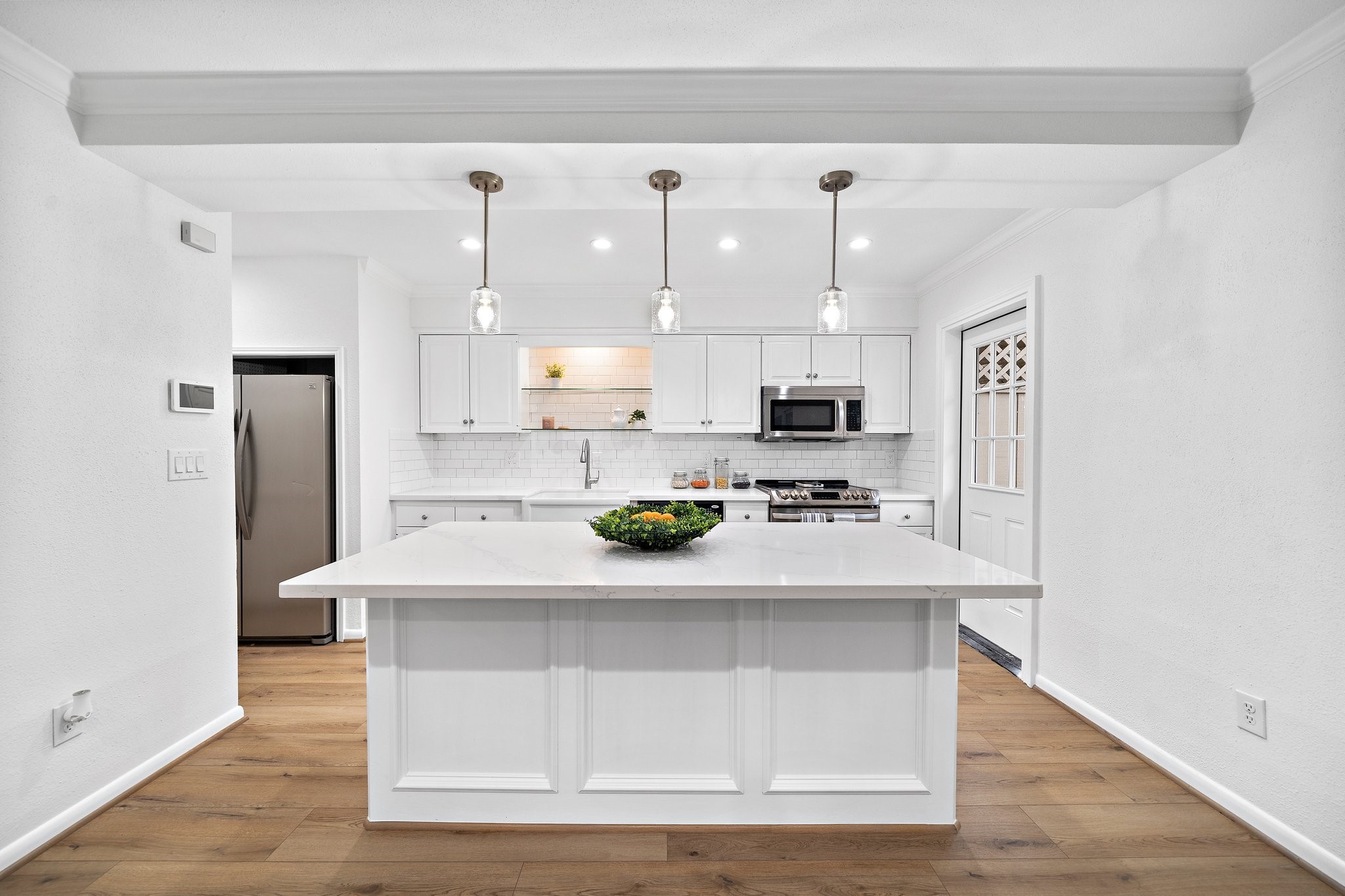 Beautiful bright kitchen with abundance of working space and storage. Accented with pendant lights. This space will be an oasis for everyone who loves to cook and entertain.