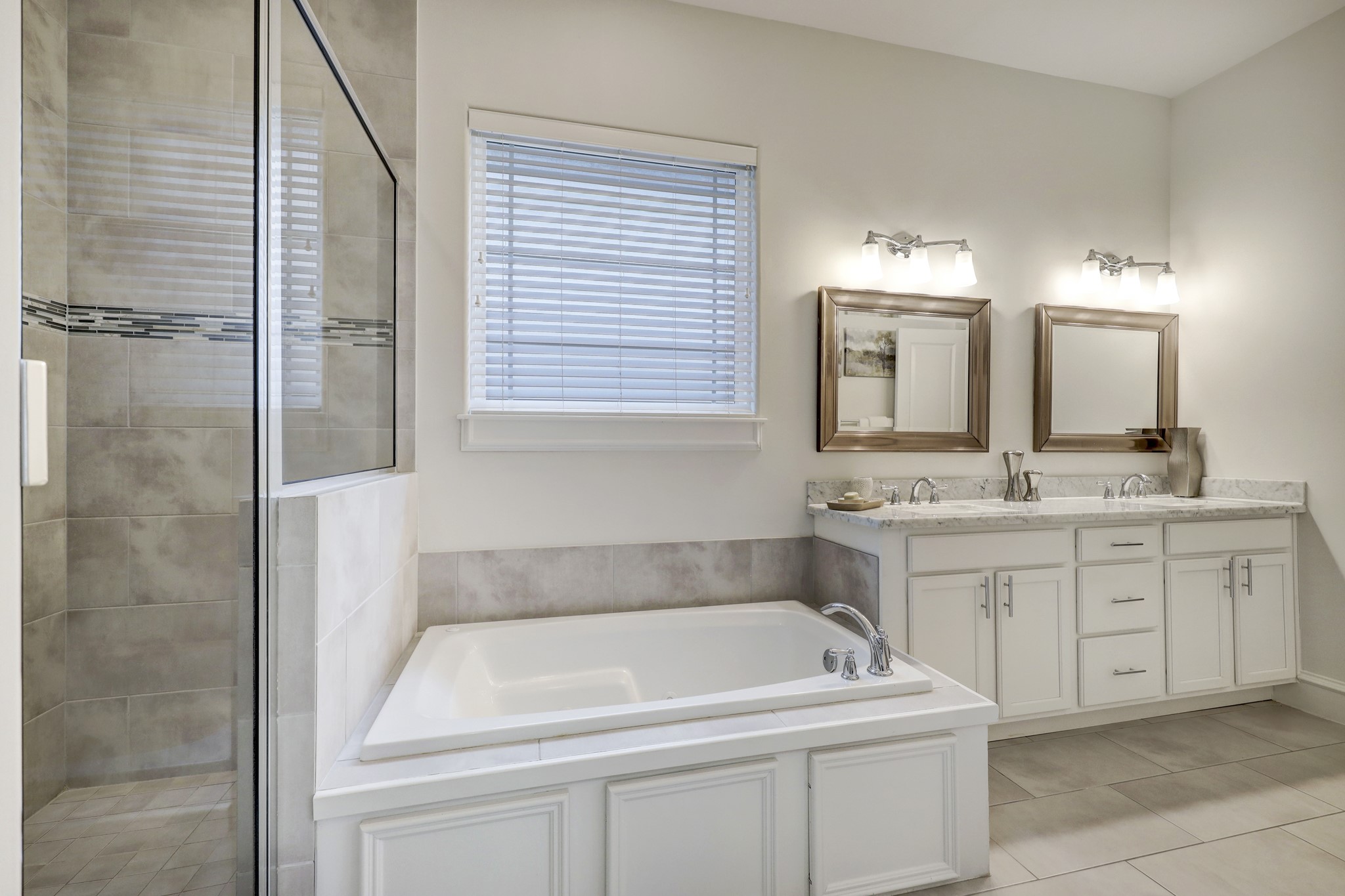 In addition to a walk-in shower, the primary bathroom features a huge jetted tub for relaxing after a long day.
