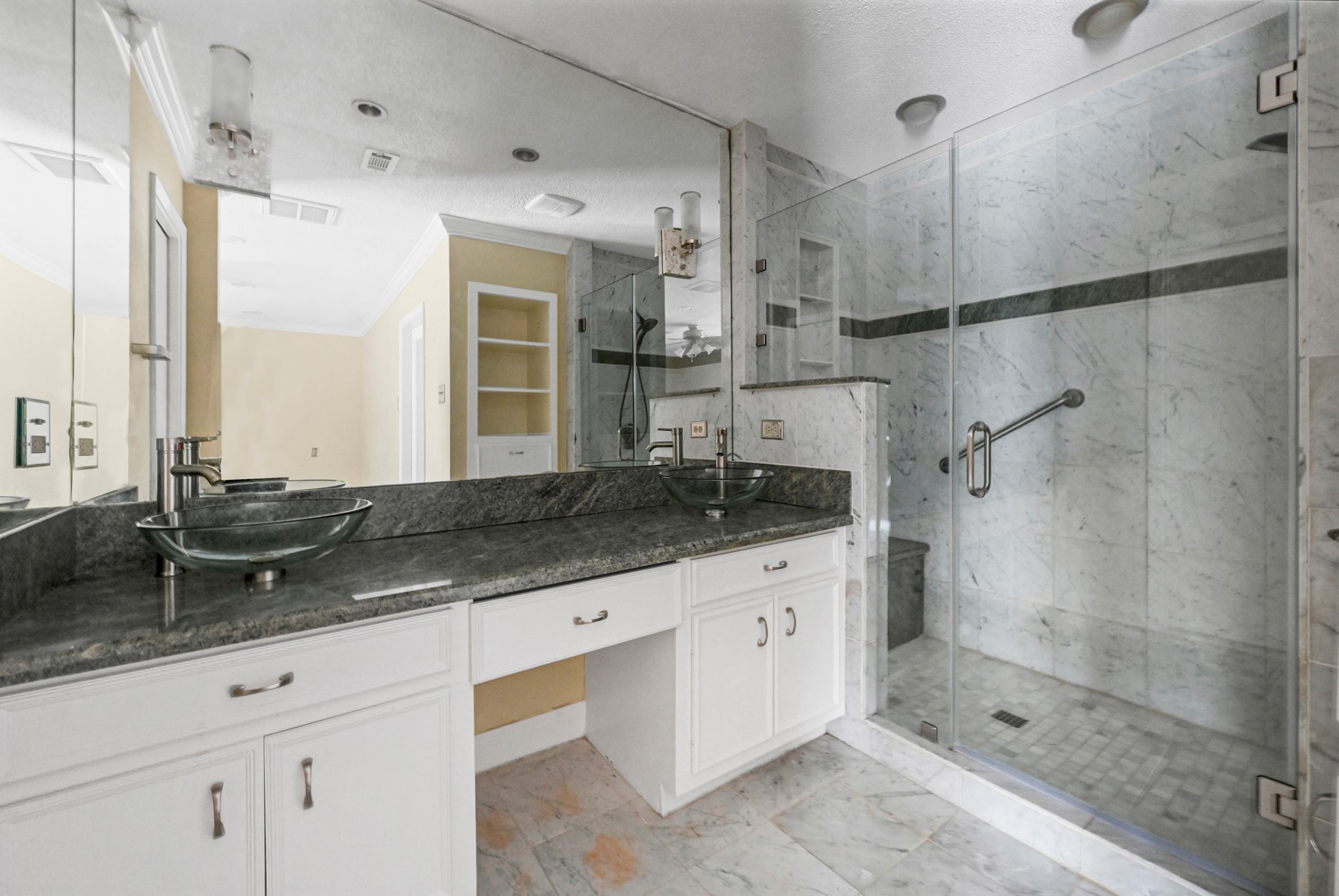 UPGRADED PRIMARY BATHROOM FEATURES DUAL VESSEL SINKS AND CUSTOM WALK-IN SHOWER!