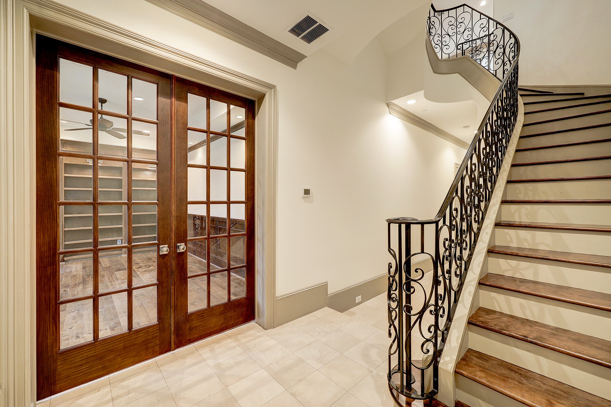 ELEGANT ENTRY SHOWING THE FRENCH DOORS TO THE LIBRARY/STUDY/CARD ROOM