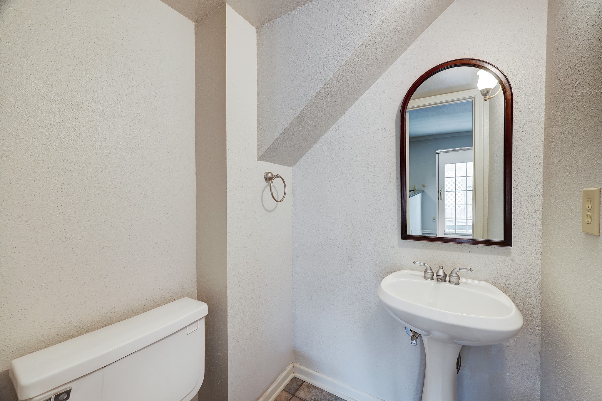 [Powder Room]
This elegant half bath serves the living areas and has a pedestal sink.