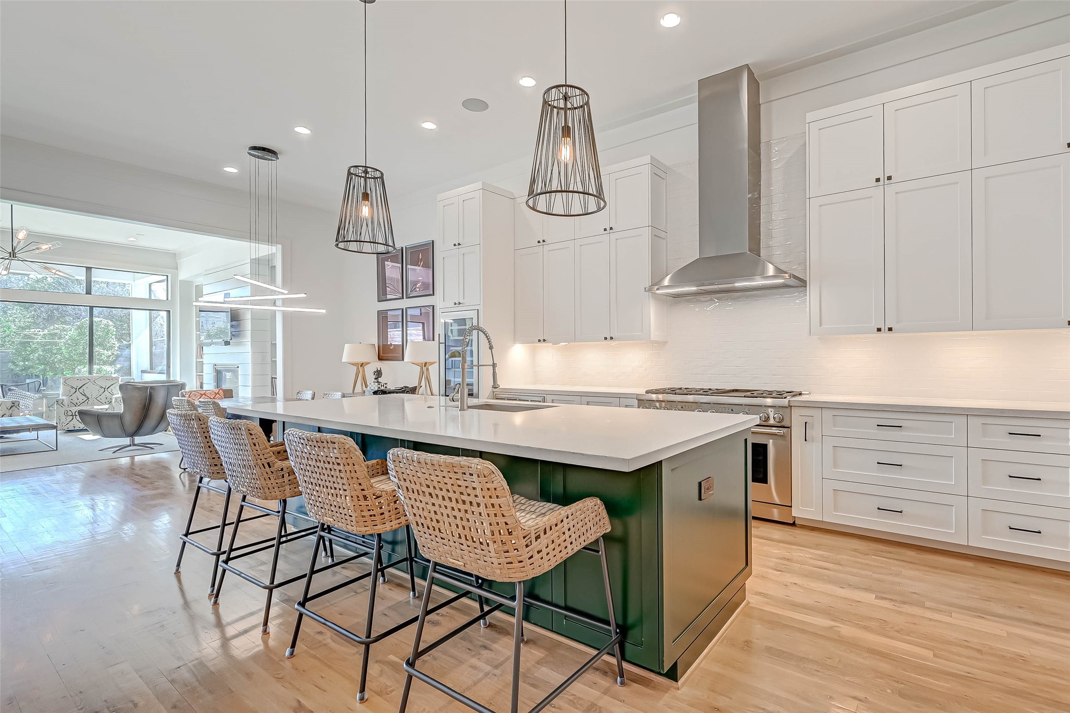 A spectacular kitchen is open and airy. Recessed lighting and exquisite drop lights over the
island accent the high ceilings and stainless-steel appliances.