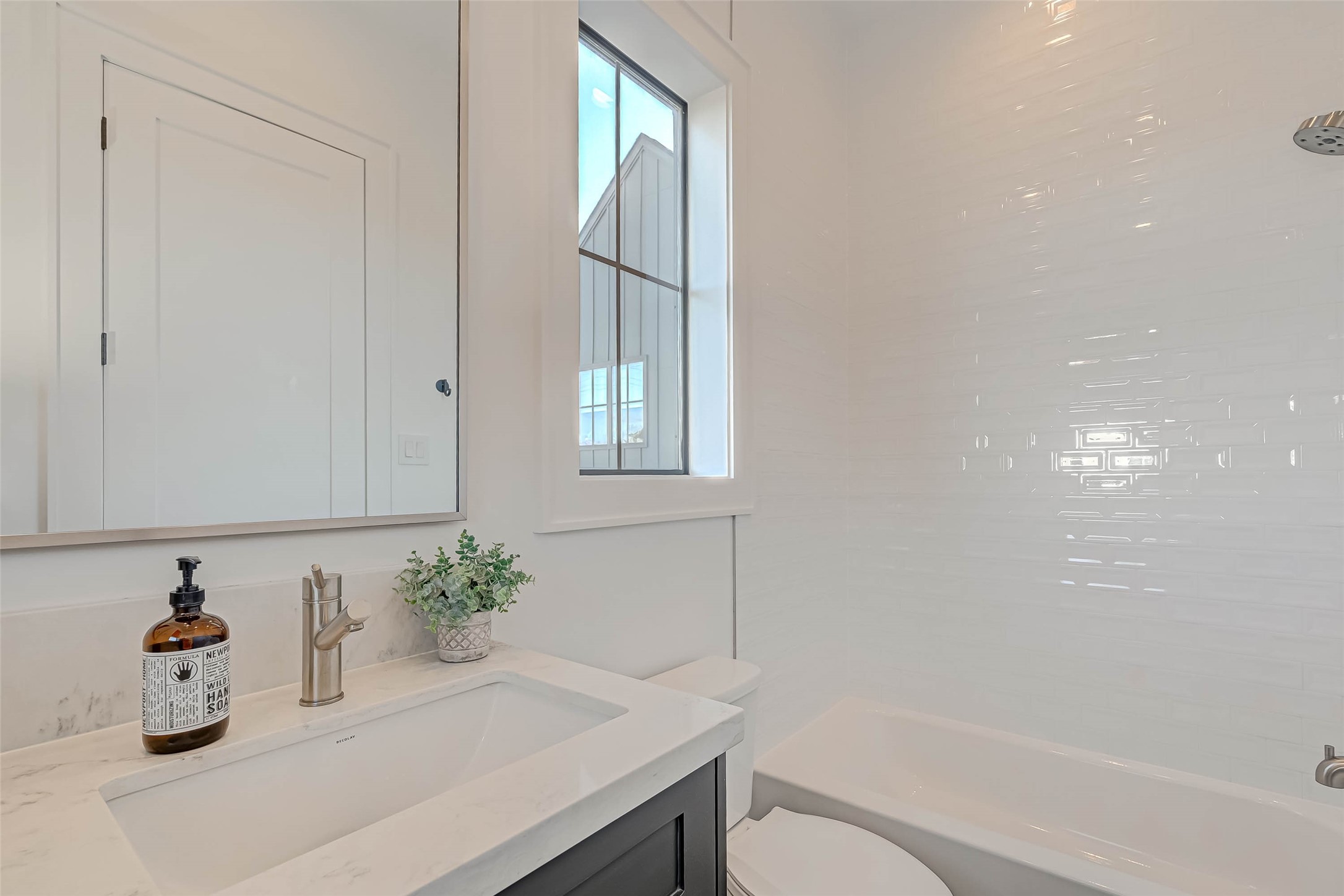 A full bath on the second floor features a fully-tiled tub and shower combination.