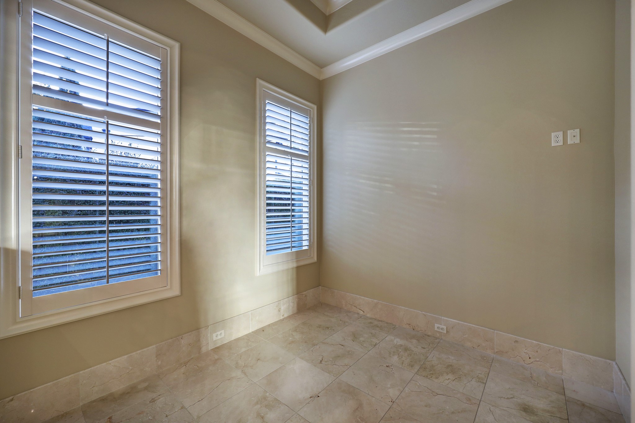 An entry vestibule with juice bar opens to the lavish owner's retreat, where you'll find a wall windows, high ceilings, and double crown molding accents.