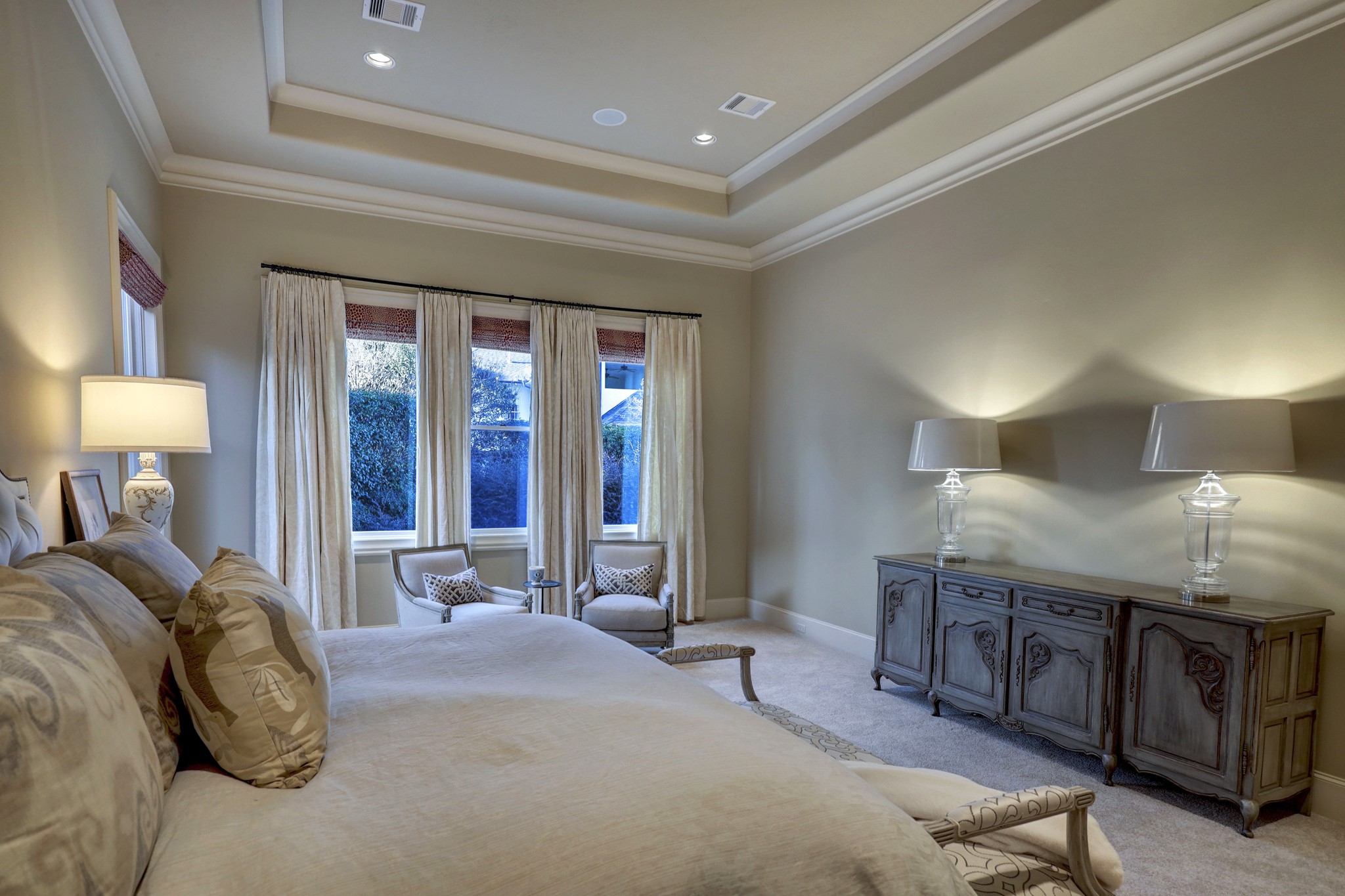 The first floor owner's suite is an oasis of calm featuring neutral carpet, a tray ceiling, can lighting, and chandelier capability.