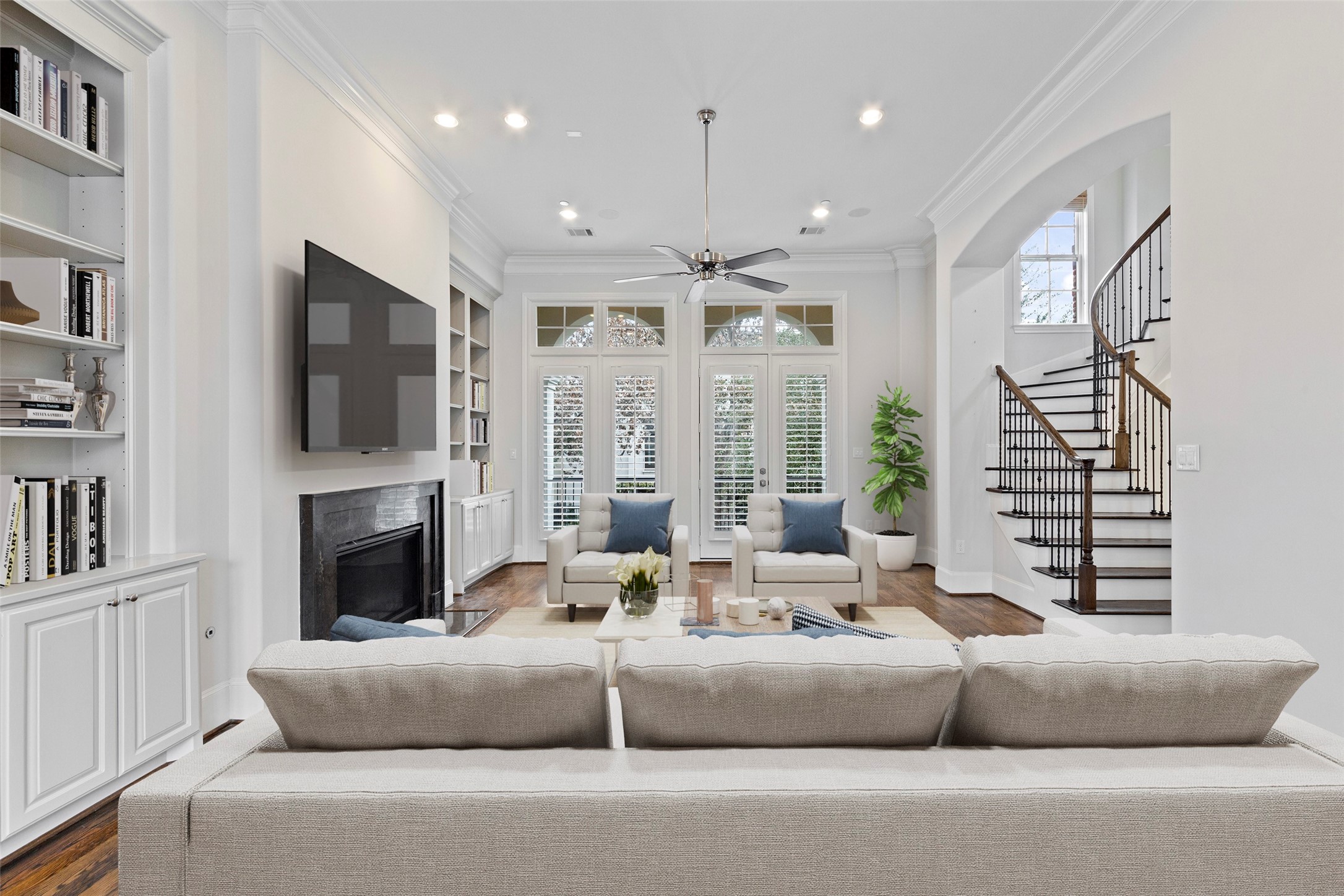The second floor is the main living area of this home, and it is simply lovely. Neutral colors, shuttered glass door openings to the patio overlooking the oaks, ample built ins and soft contemporary touches everywhere. *Photo virtually staged