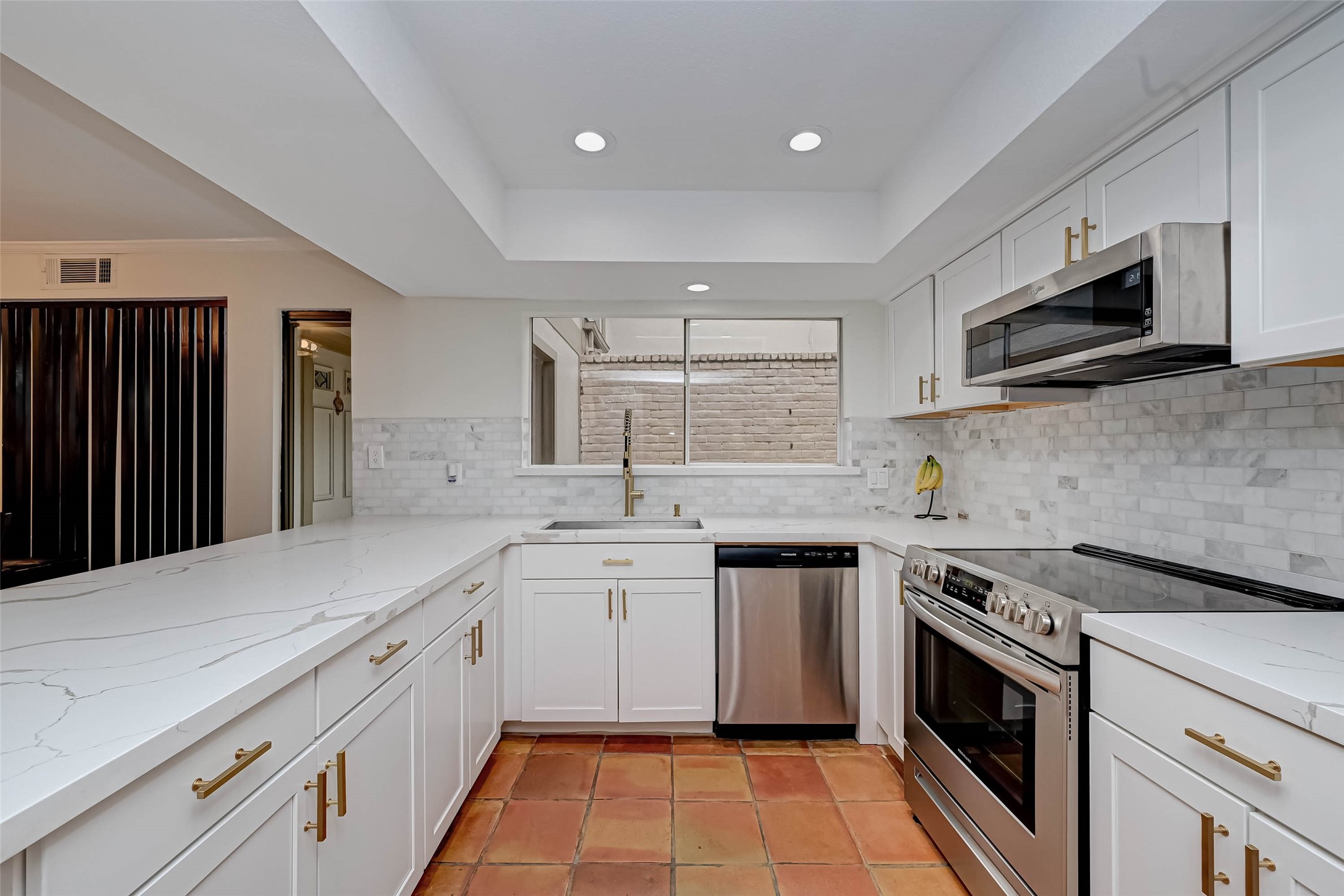 No expense was spared in the remodel of this townhome, in the kitchen especially. Beautiful quartz countertops, white cabinets with gold hardware and stainless steel appliances.