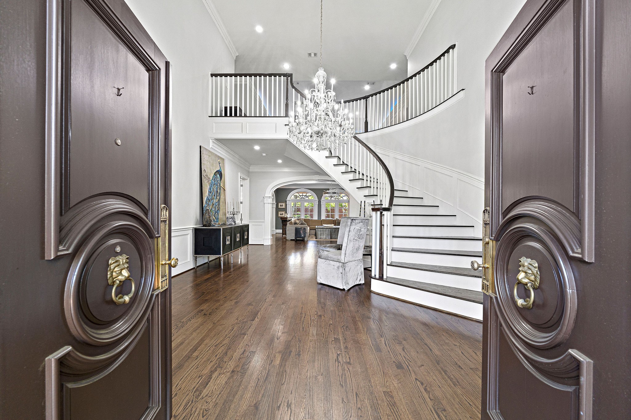 Elegant double doors usher you into the foyer and up the majestic grand staircase.
