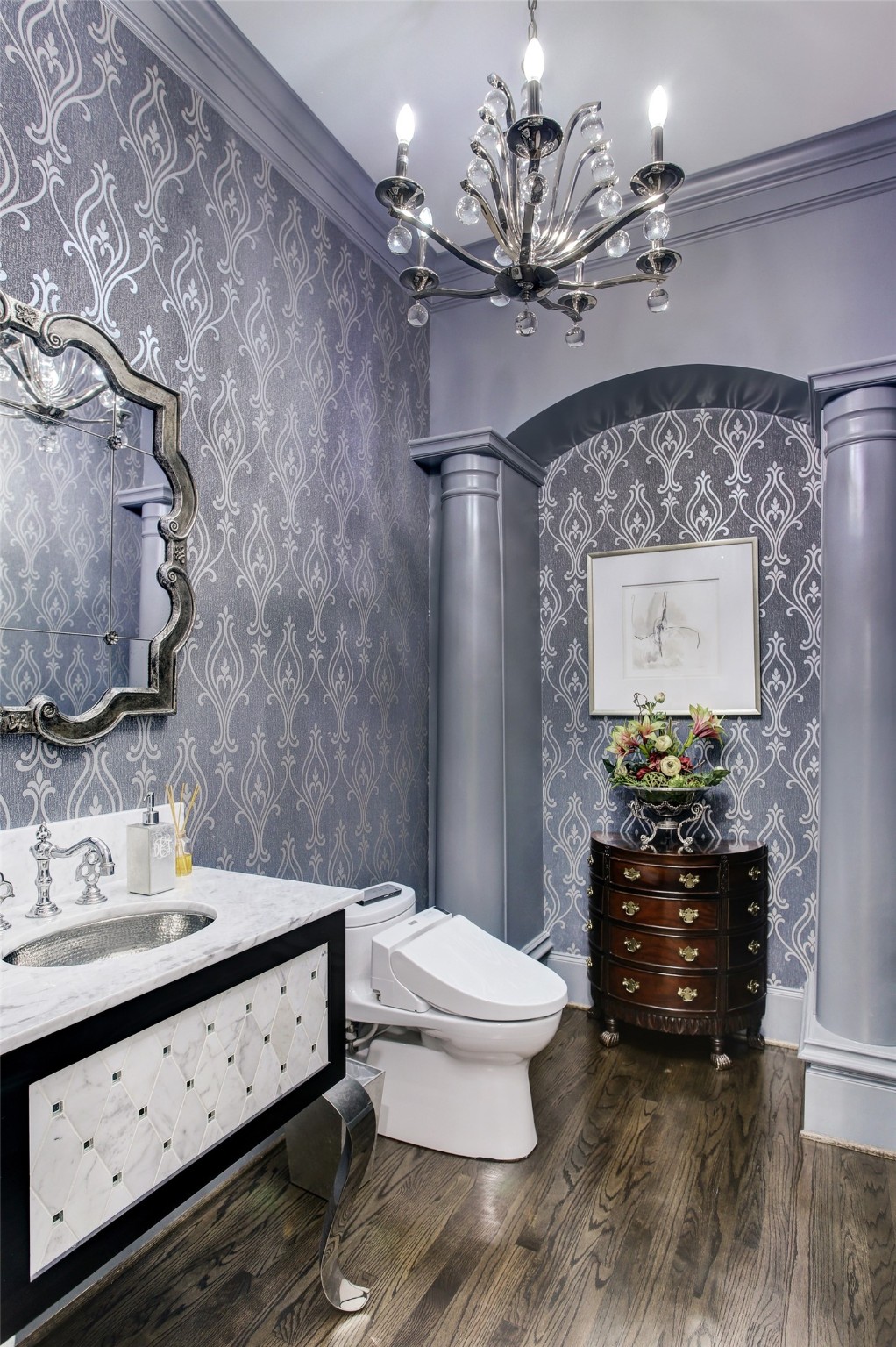 The guest bathroom, with custom vanity, sink, counter and Toto toilet, is consistent with the elegant style found throughout this home.