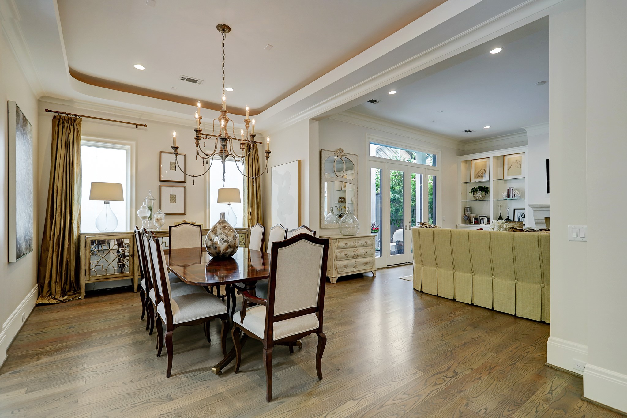 The elegant dining room has a cove ceiling with a gorgeous designer chandelier and large picture windows offer an abundance of natural light.