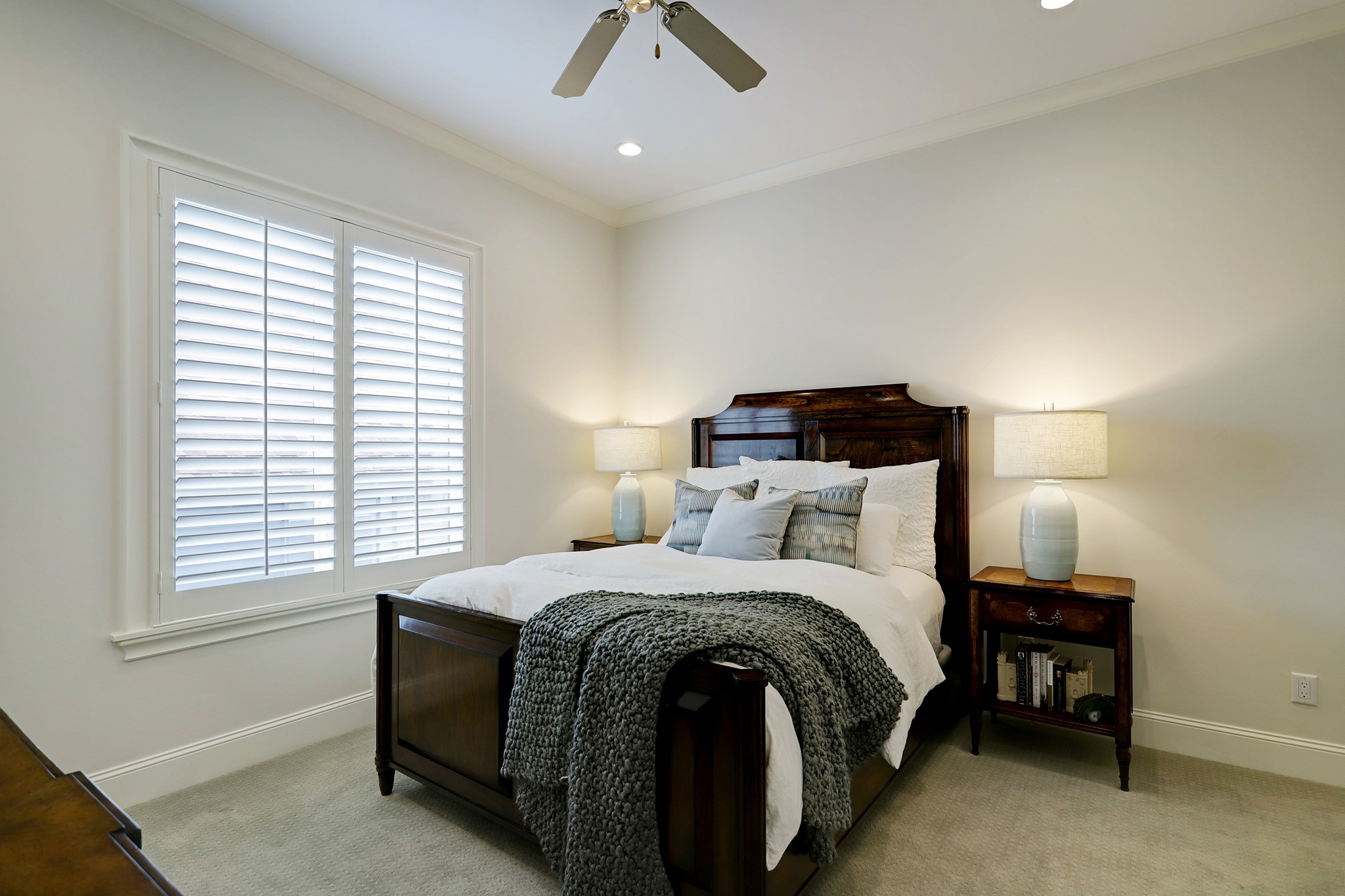 secondary bedroom with ensuite bath, crown molding and nice closet space.