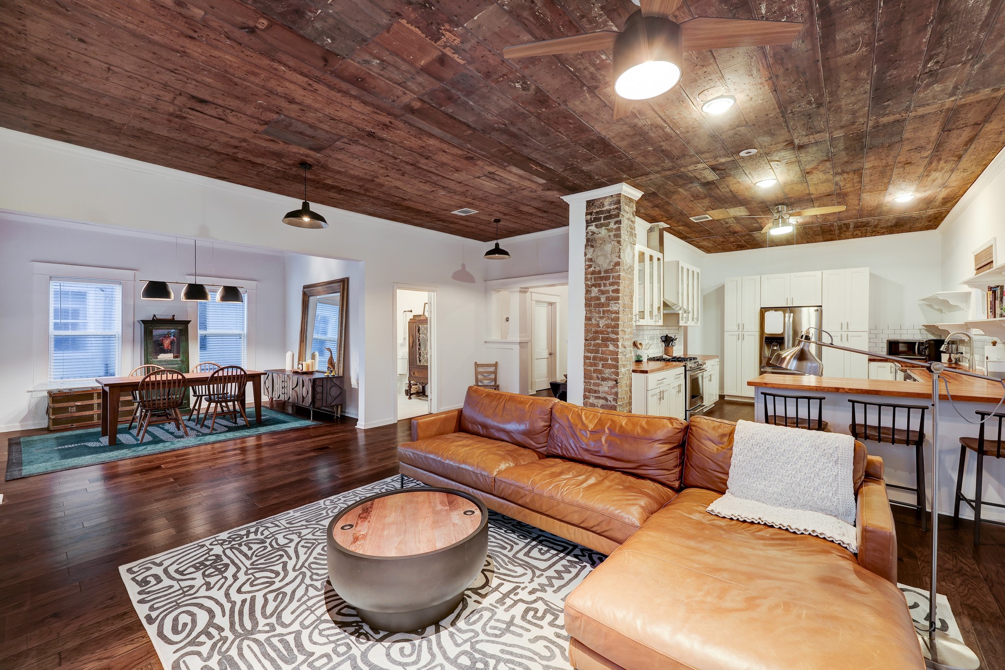 From this angle, we can admire the gorgeous ceilings, the original brick from a long-gone wood burning stove, the vintage window casings, and craftsman built-ins.