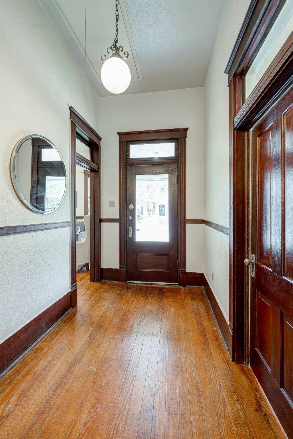 Grand foyer entryway with original heart of pine floors and 11 foot+ ceilings.