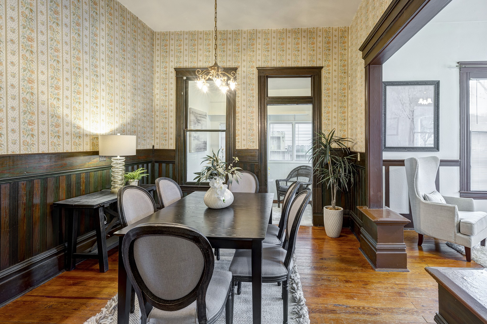Beadboard wraps around the formal dining room with period-style wallpaper.