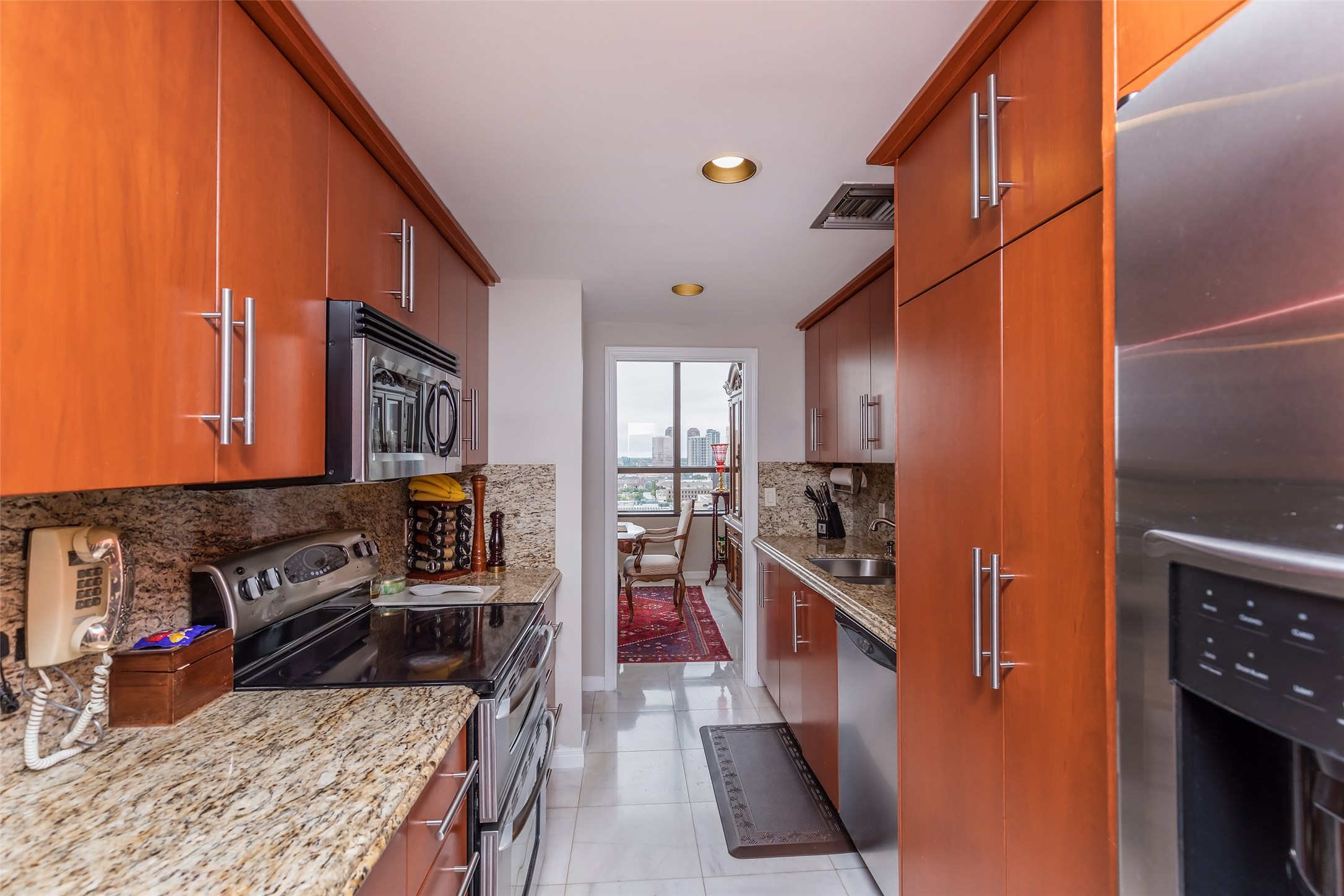 Updated kitchen with stainless steel appliances, immediately adjacent to dining area.
