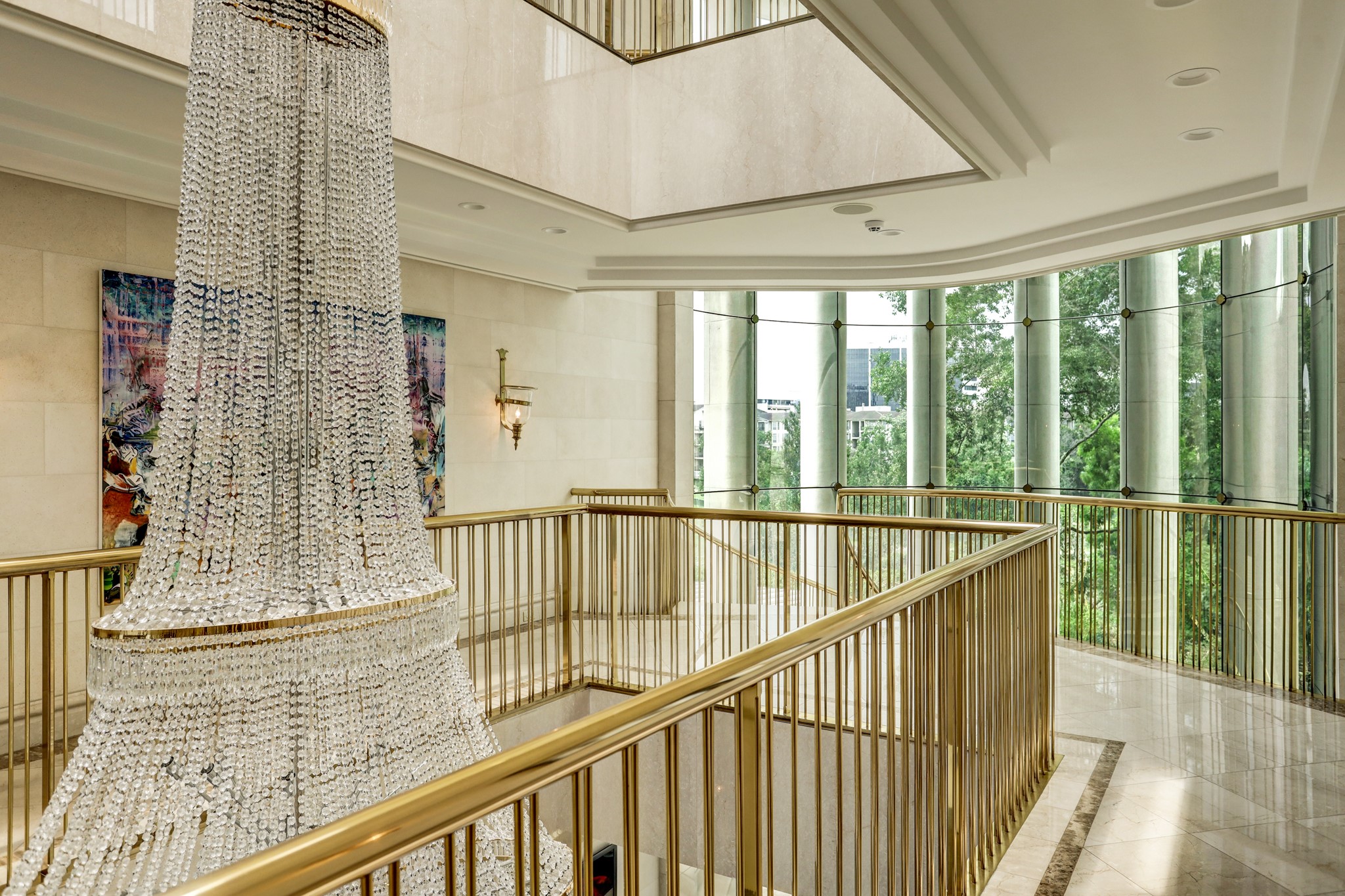 Another view of the second floor Gallery Hall showcases the honed limestone-block faux finished walls and the decorative recessed ceiling. To the left of the frame is the recessed elevator foyer which lies just beyond the exquisite 5’ wide marble cased opening. 
