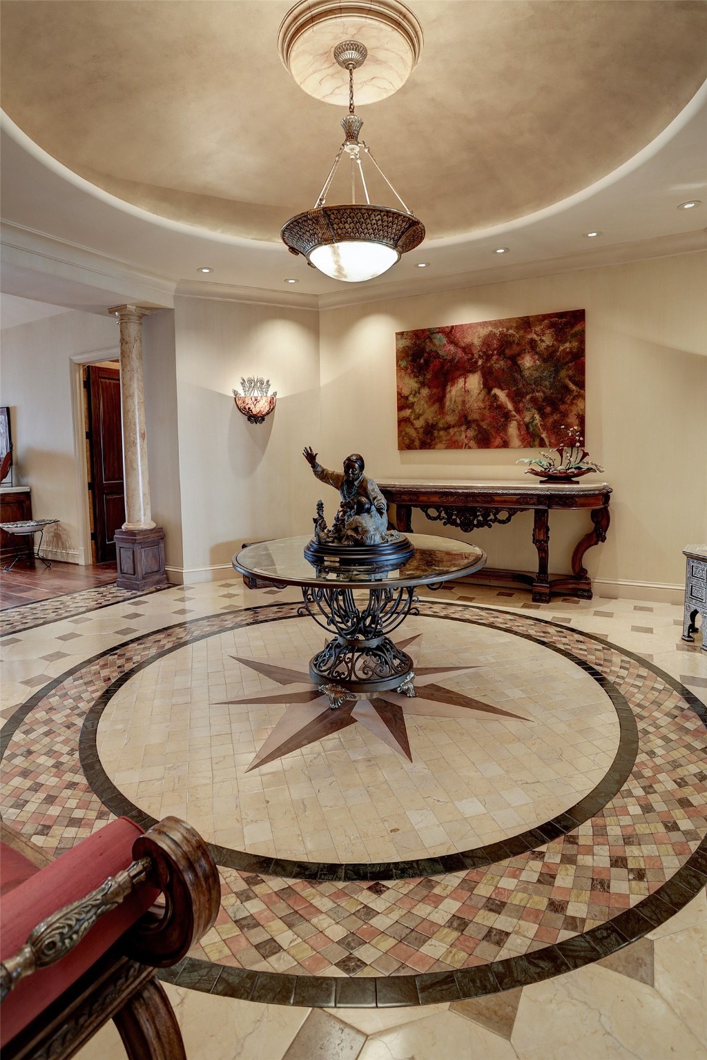The large Foyer (19 x 23) welcomes guests as they enter from the elevator.  Special features include the mock domed ceiling with faux gilt and faux marble medallion and art lighting.